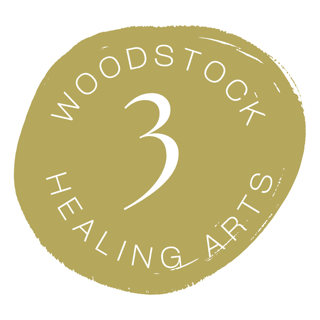 Gold circular badge with white text that reads "Woodstock 3 Healing Arts" in a circular arrangement around a large number 3 in the center.