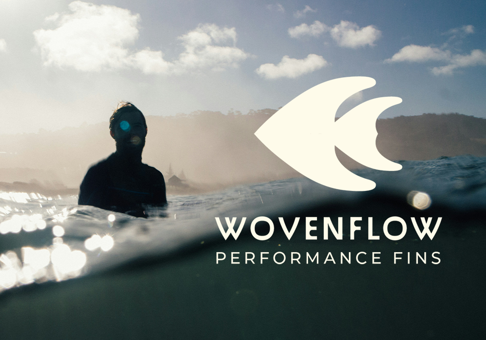 A surfer in the water with a sunset or sunrise in the background, overlay with the Wovenflow logo and text 'Performance Fins'.