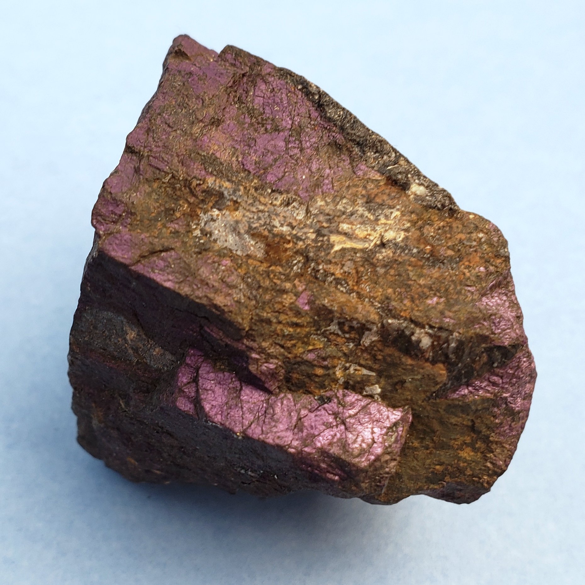 Purpurite. A rough, irregularly shaped rock with purple and brown mineral deposits.