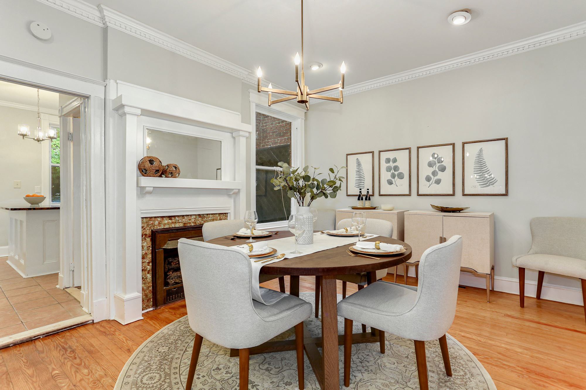 GEORGETOWN CT NW, WASHINGTON, DC:
This charming dining room features a simple round table setup with beautiful plates and utensils, complemented by a stunning plant centerpiece. A stylish hanging chandelier adds an elegant touch, creating a warm and