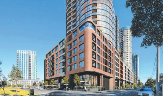 Modern high-rise buildings in an urban area with clear blue sky and trees.