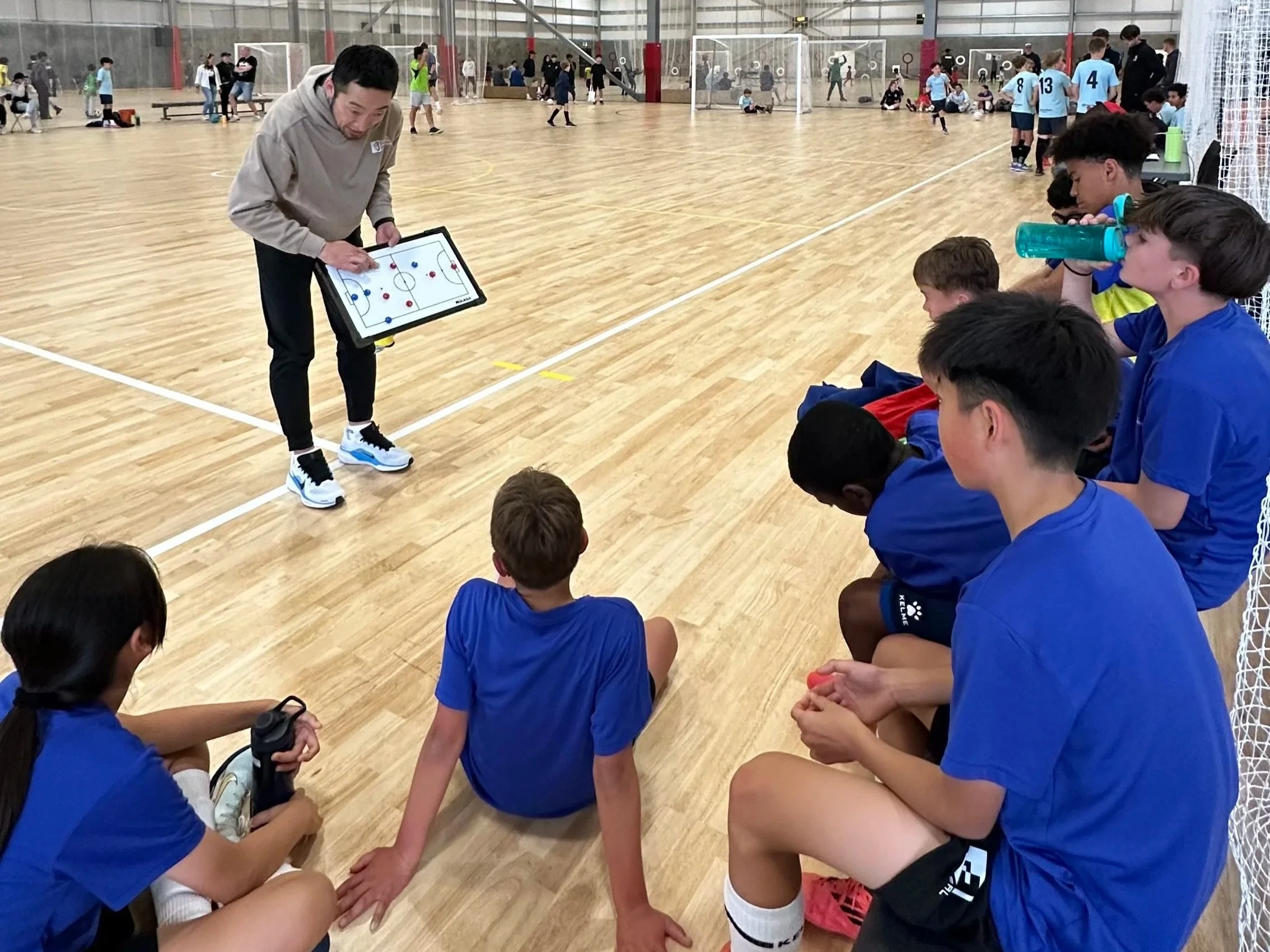 House on hill with snow-capped mountains in background