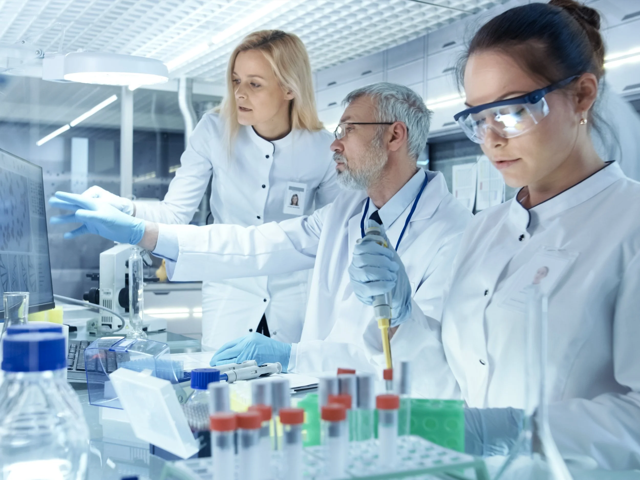 Scientists in a laboratory analyzing data and conducting experiments.