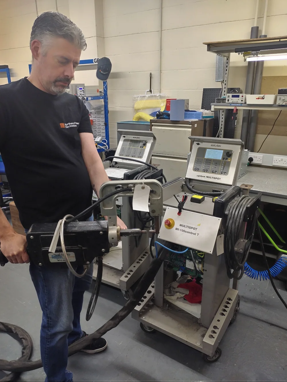 NPE engineer inspecting industrial HMI control systems at Northern Power Electronics workshop Newcastle