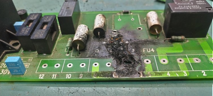 NPE engineer inspecting industrial electronic control board at Newcastle workshop
