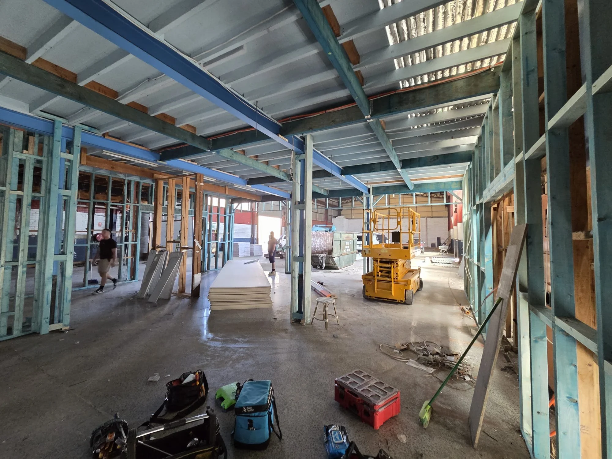 Construction site with framing, tools, and equipment inside a building under construction.