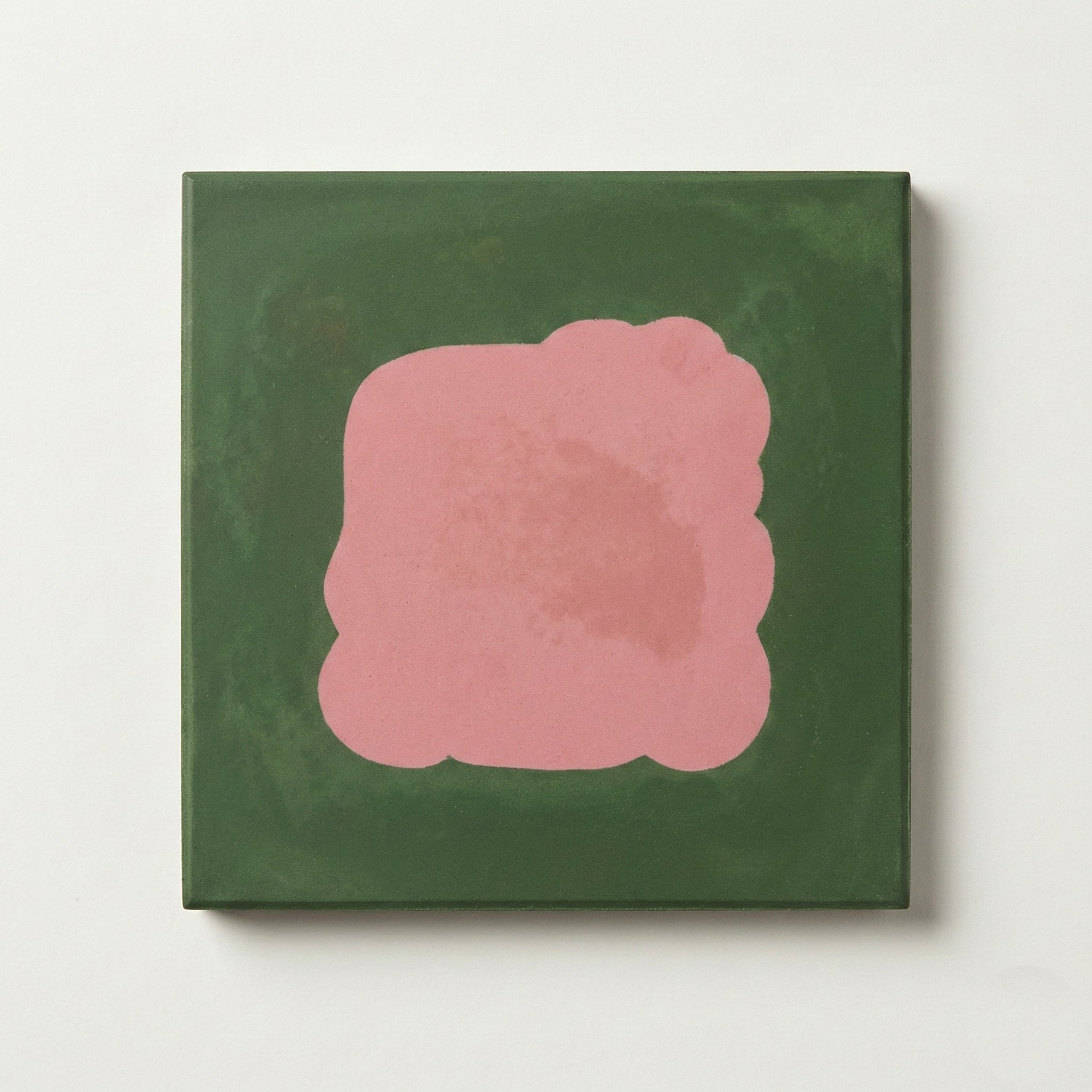 Abstract pink shape on a green background canvas.
