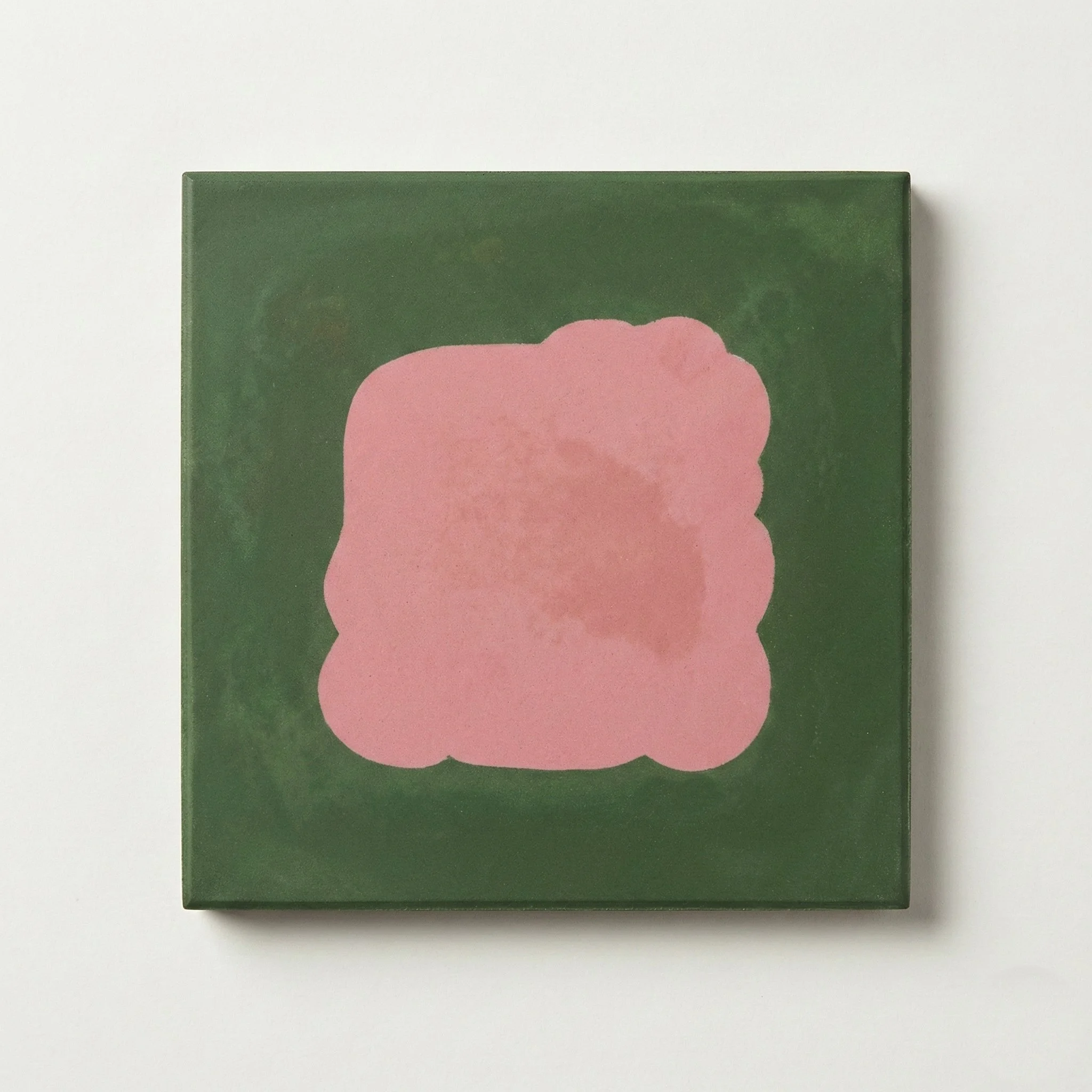 A square painting with a dark green background and a pink abstract shape in the center.