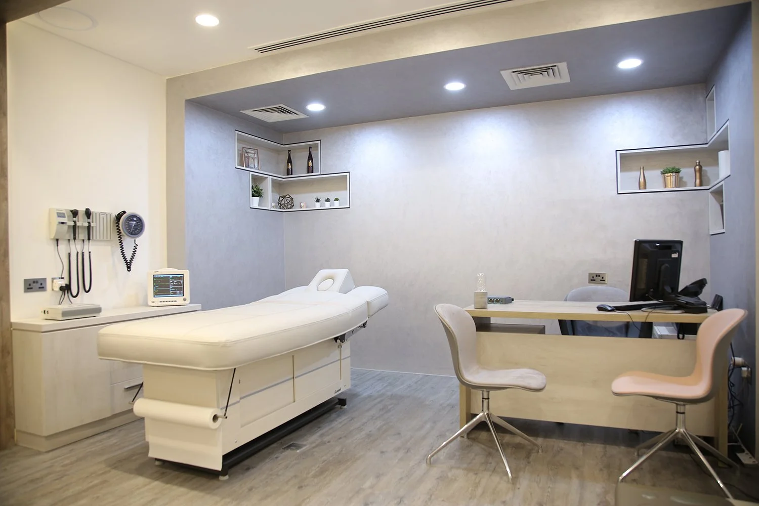 This modern clinic design features open yet private treatment rooms, offering a spacious layout with distinct zones for patient consultation and treatment, ensuring a personalized experience.