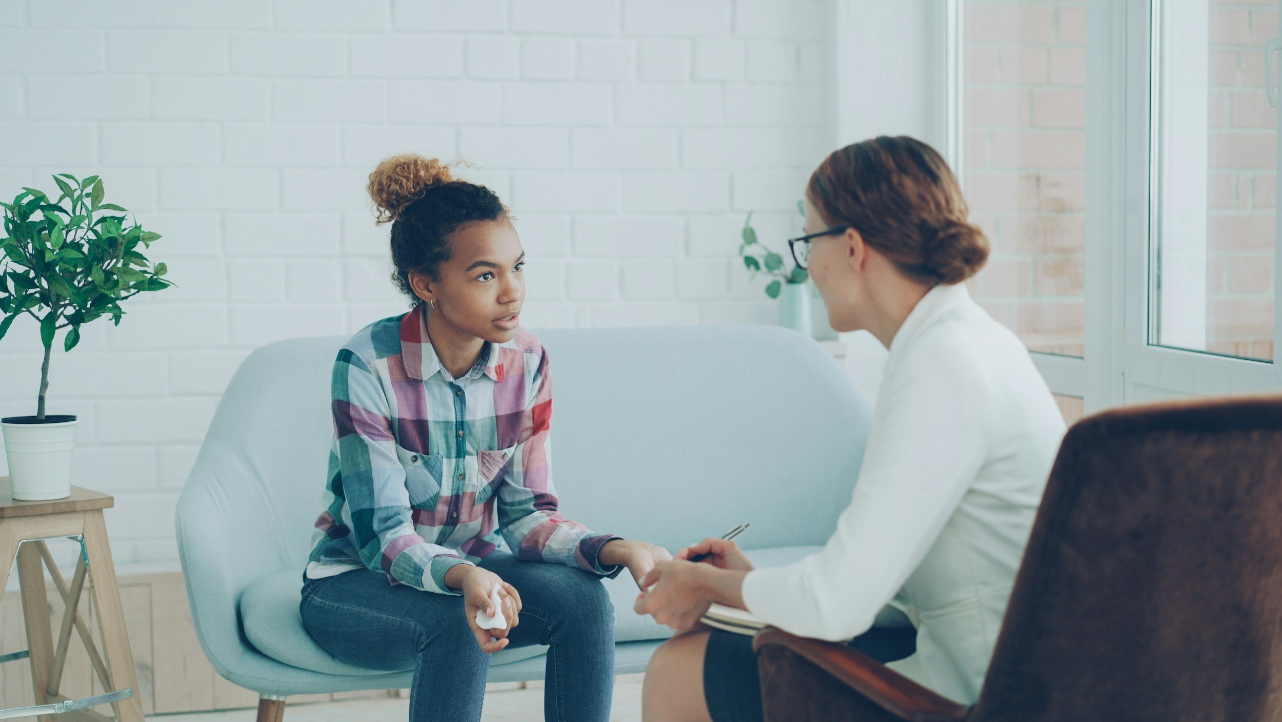 Two people facing each other having a discussion