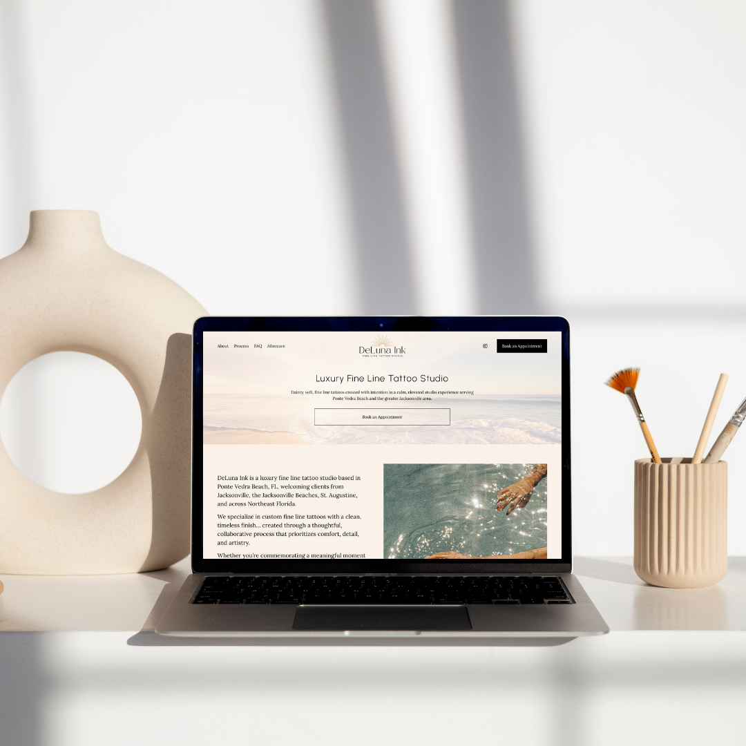 A photo of a macbook laptop showing a local business website.