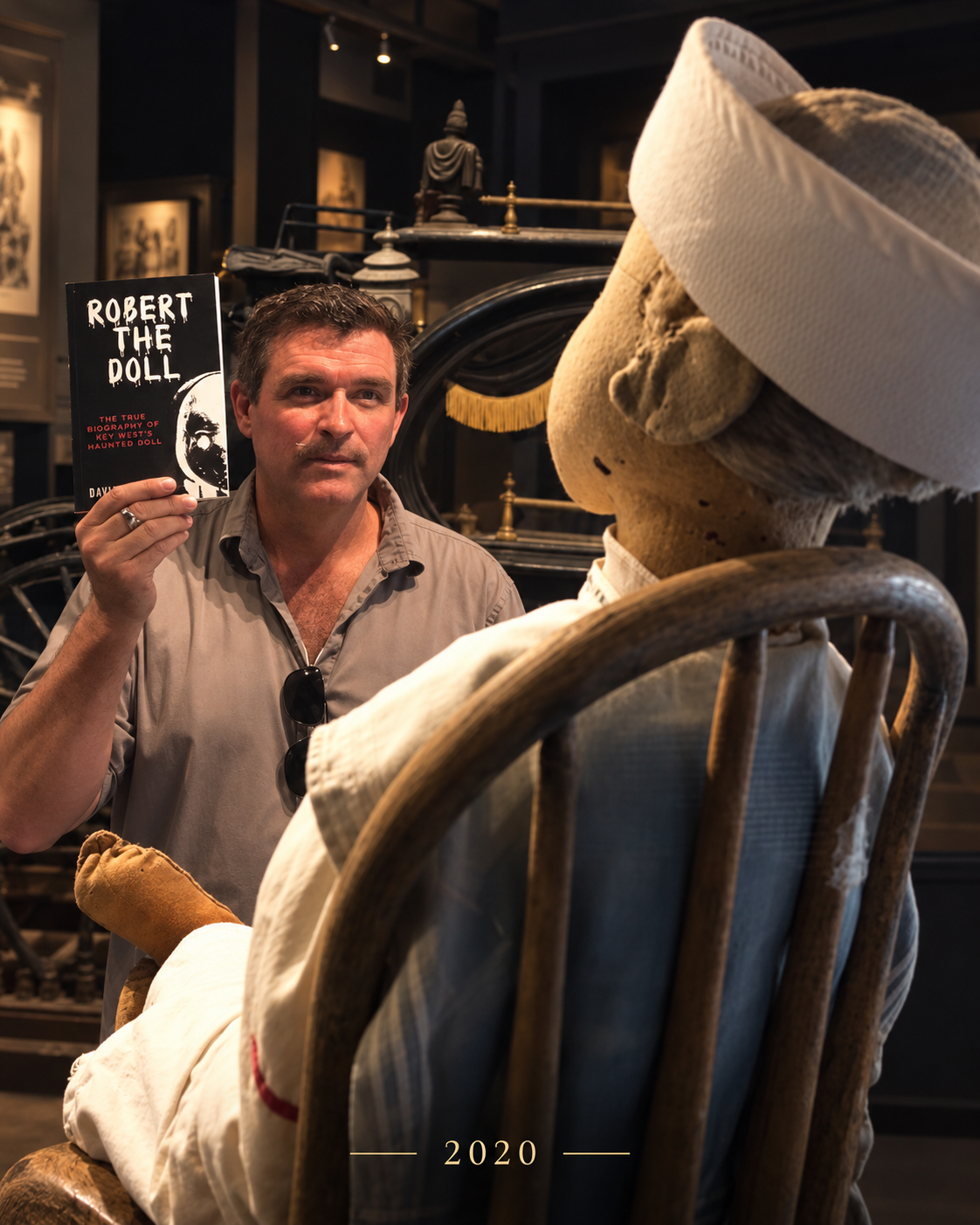 David L. Sloan with Robert the Doll and his book Robert the Doll at Fort East Martello in Key West.
