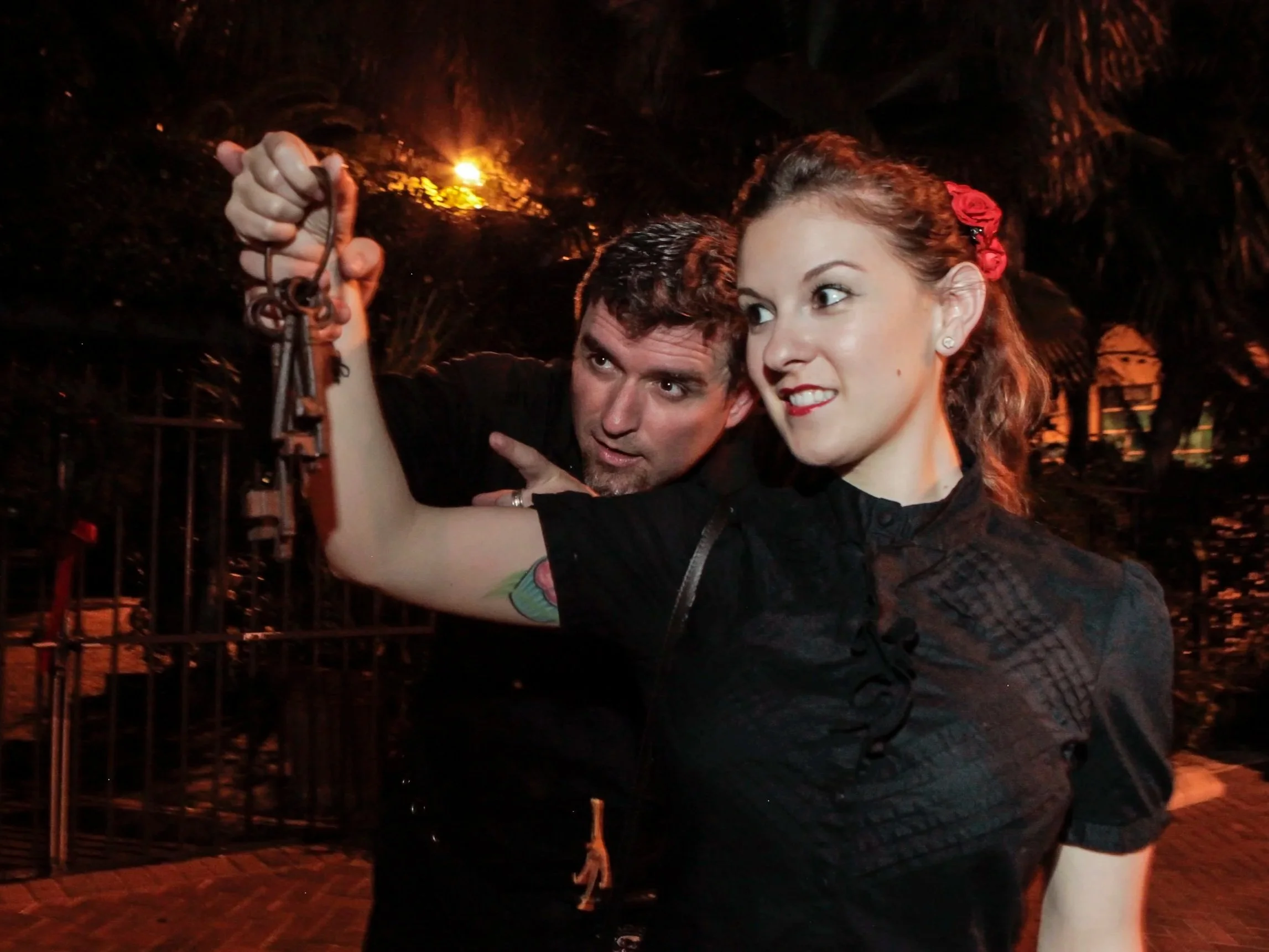 Guests testing out a trigger object during a private nighttime paranormal experience in Key West.