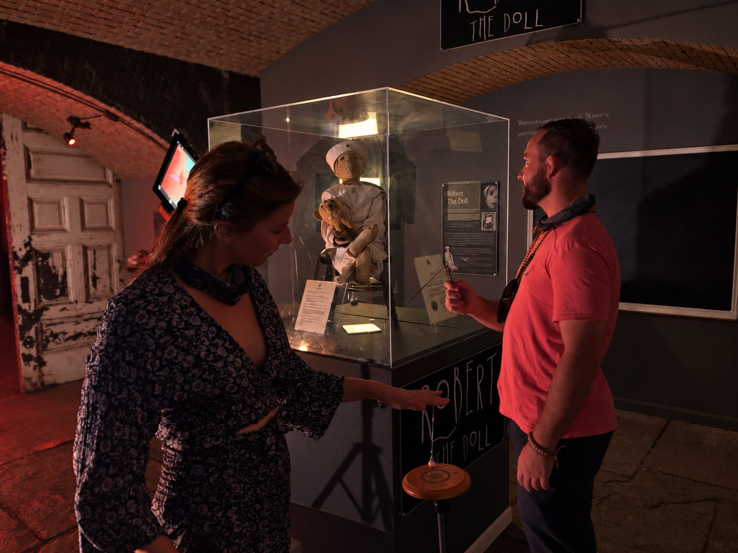 Guests conducting a paranormal investigation beside Robert the Doll at Fort East Martello