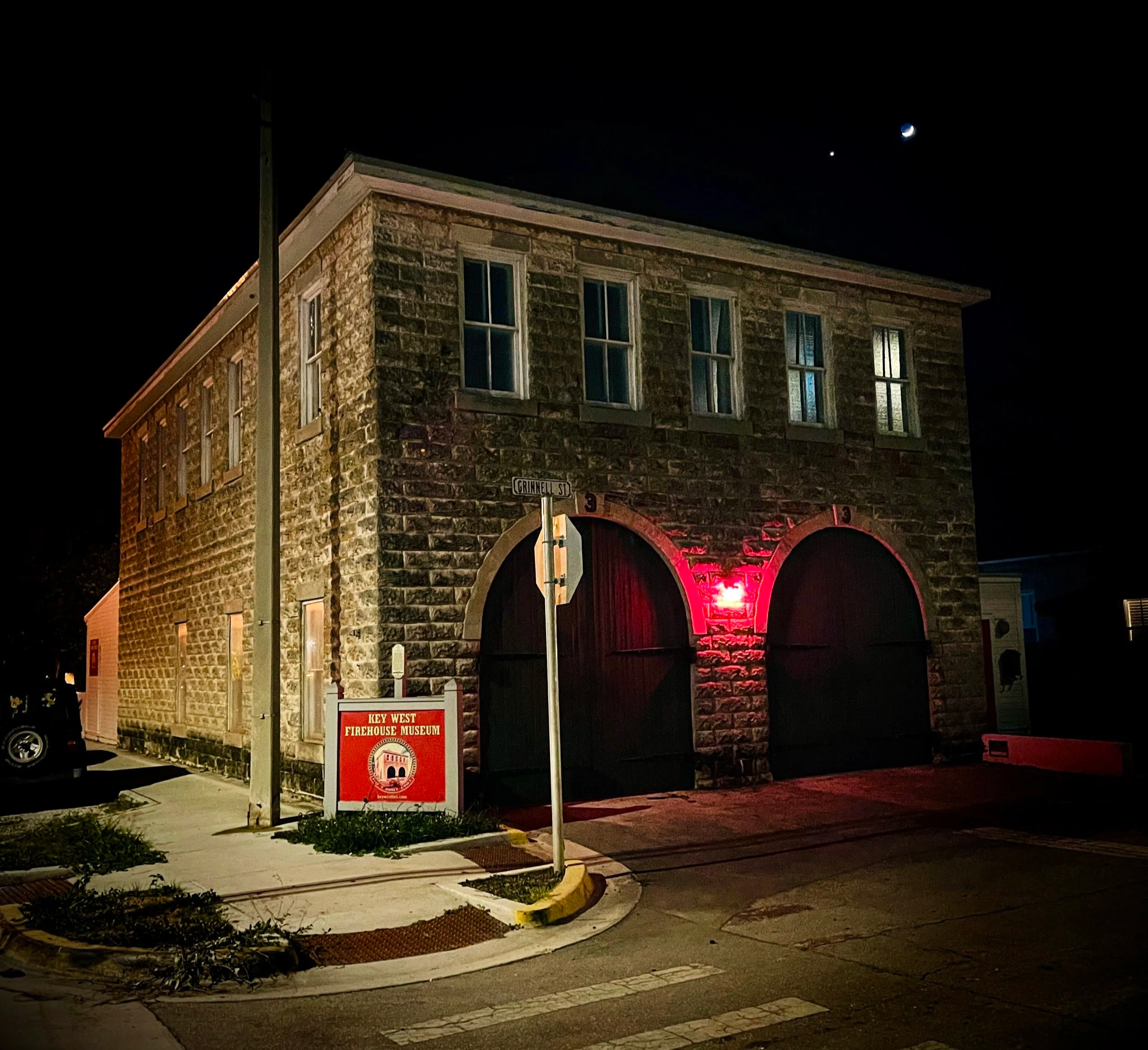 Historic Key West Firehouse No. 3 at night with a crescent moon above the building
