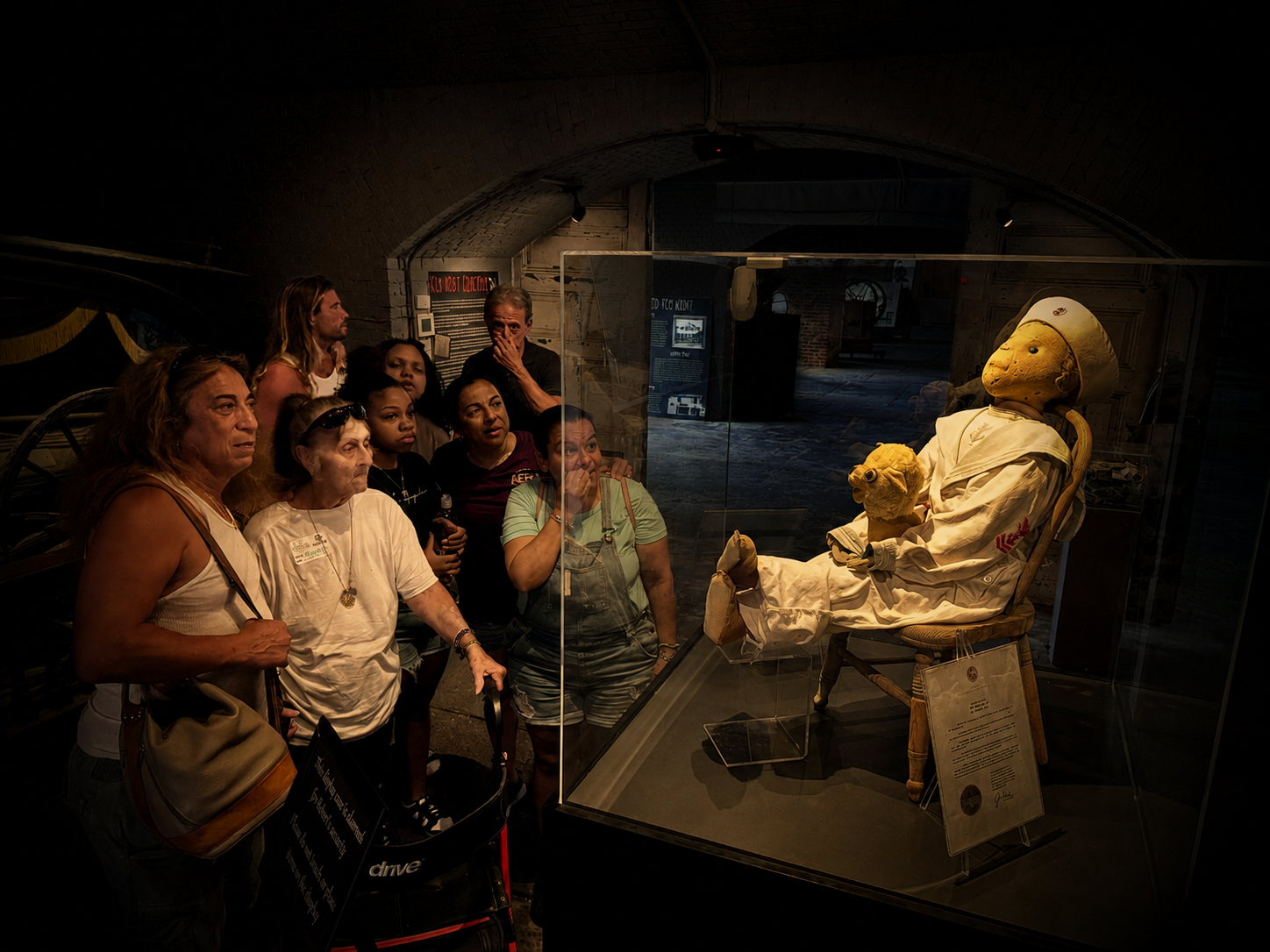 Guests meeting Robert the Doll after dark inside Fort East Martello Museum in Key West