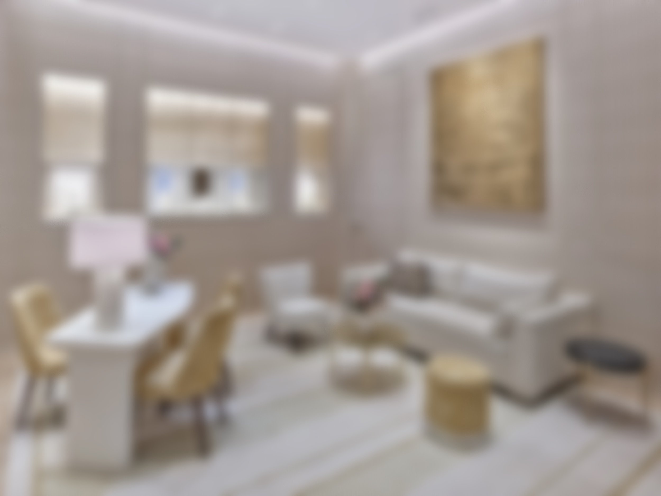 Blurred image of a living room with a dining table, chairs, sofa, artwork, and windows letting in natural light.