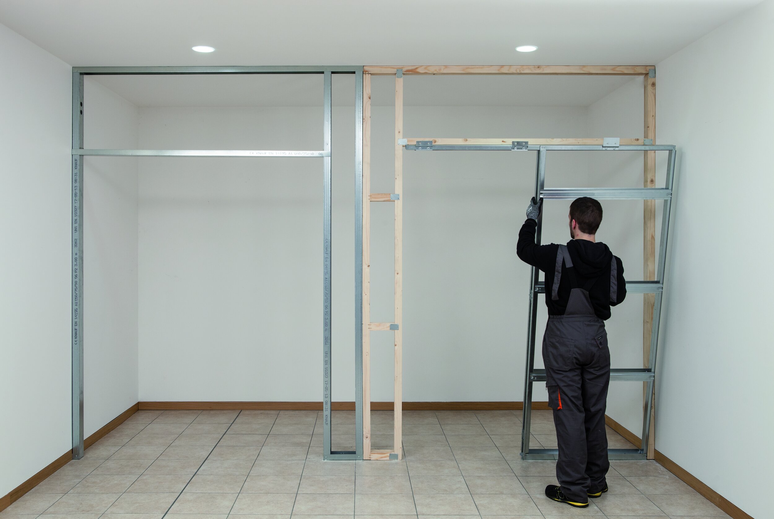 Man showing how to fit a rocket pocket door frame