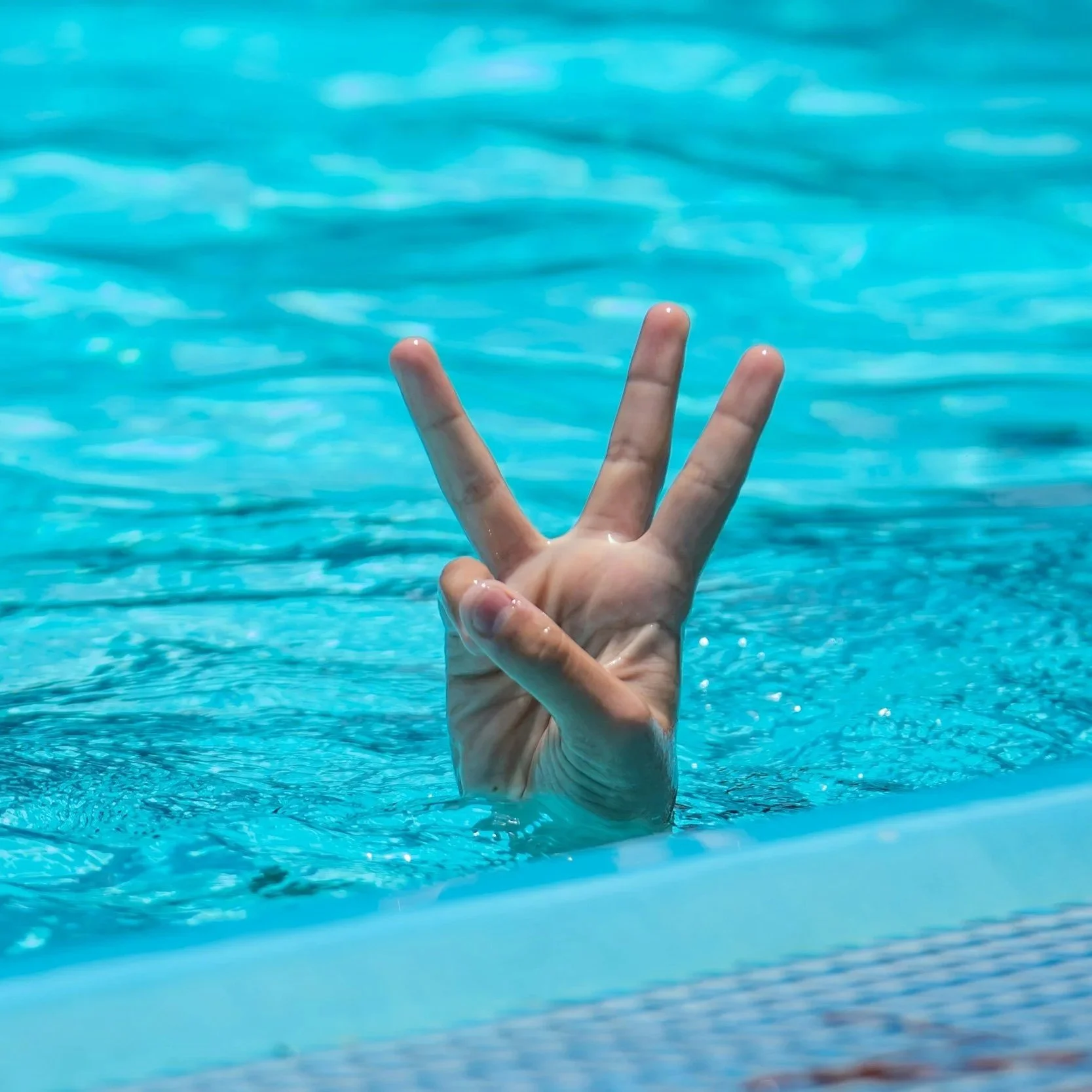 Close-up of a hand holding a red pushpin to mark a location on a detailed city map with additional red pushpins placed on the map.