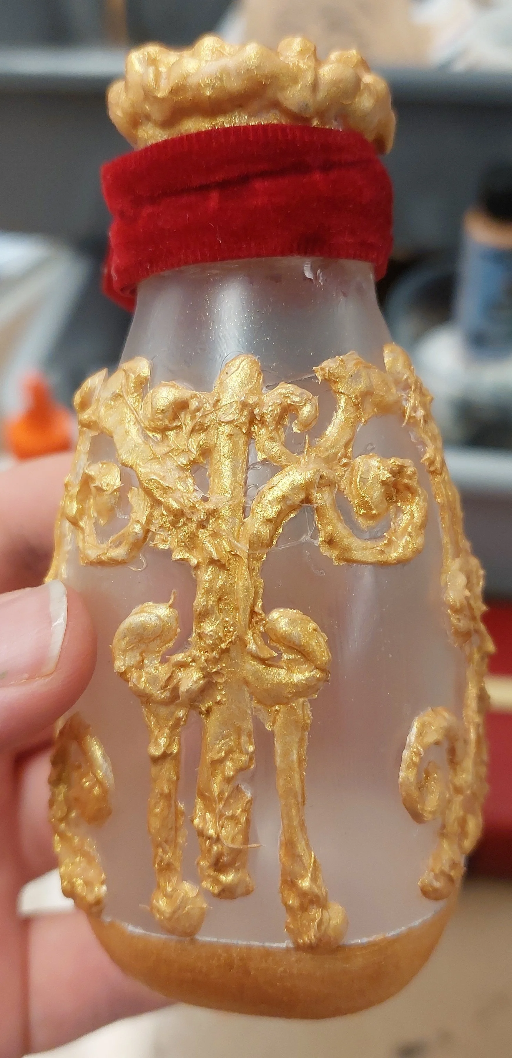 Complete poison bottle. Red ribbon goes through the loop on the cork so that it stays attached when opened. 