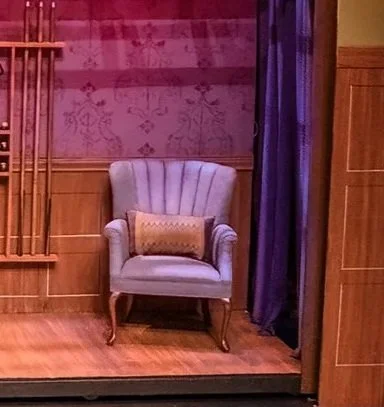 Completed cheat reupholstered chair. Finished in one afternoon, painted using a mix of latex paint and fabric softener. The treatment did not crack or show any damage through the run of the show.