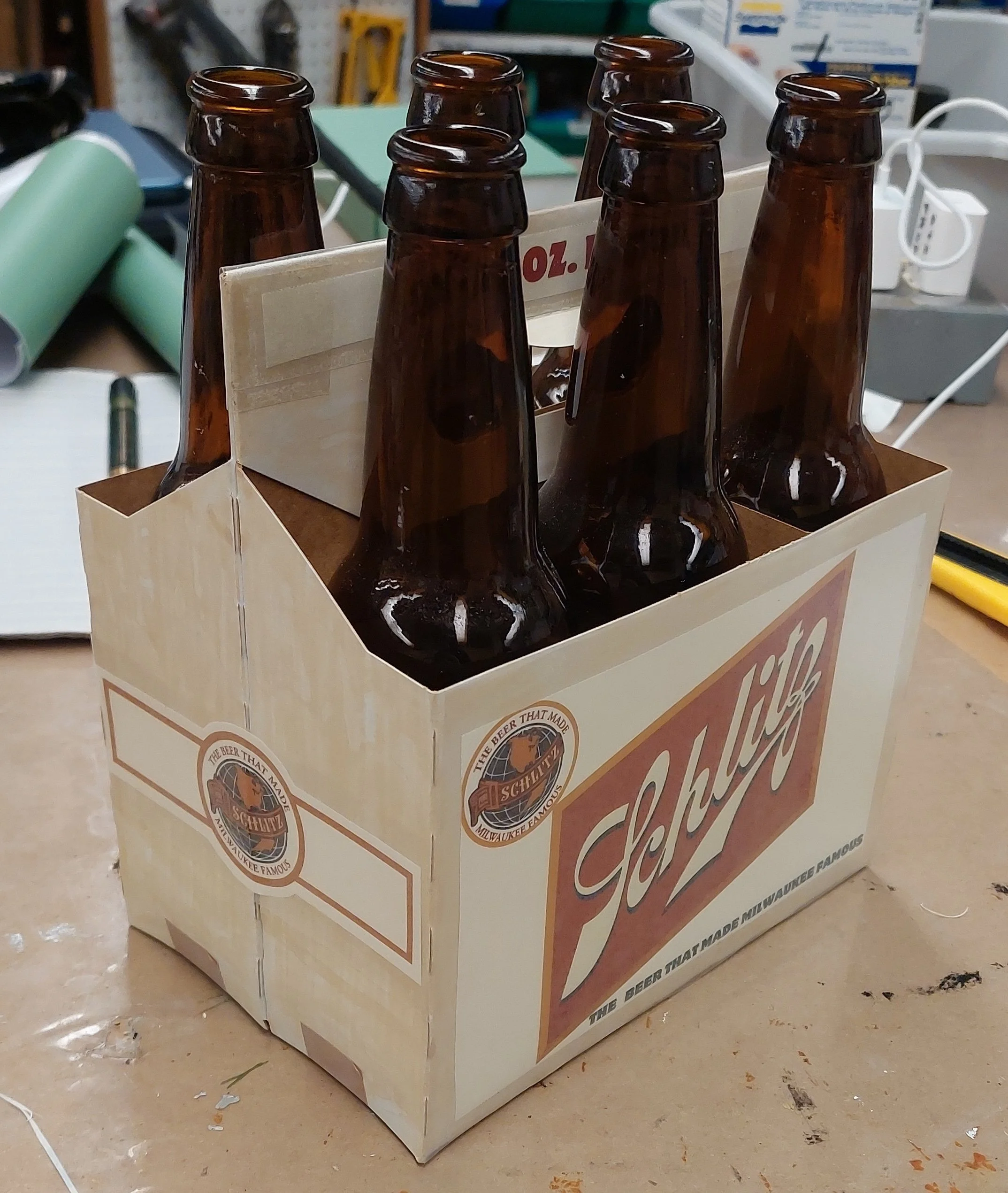 The Modge Podge coating was warping the paper and not water resistent. At this point, the prop became drinkable and breakable, so new methods were required.