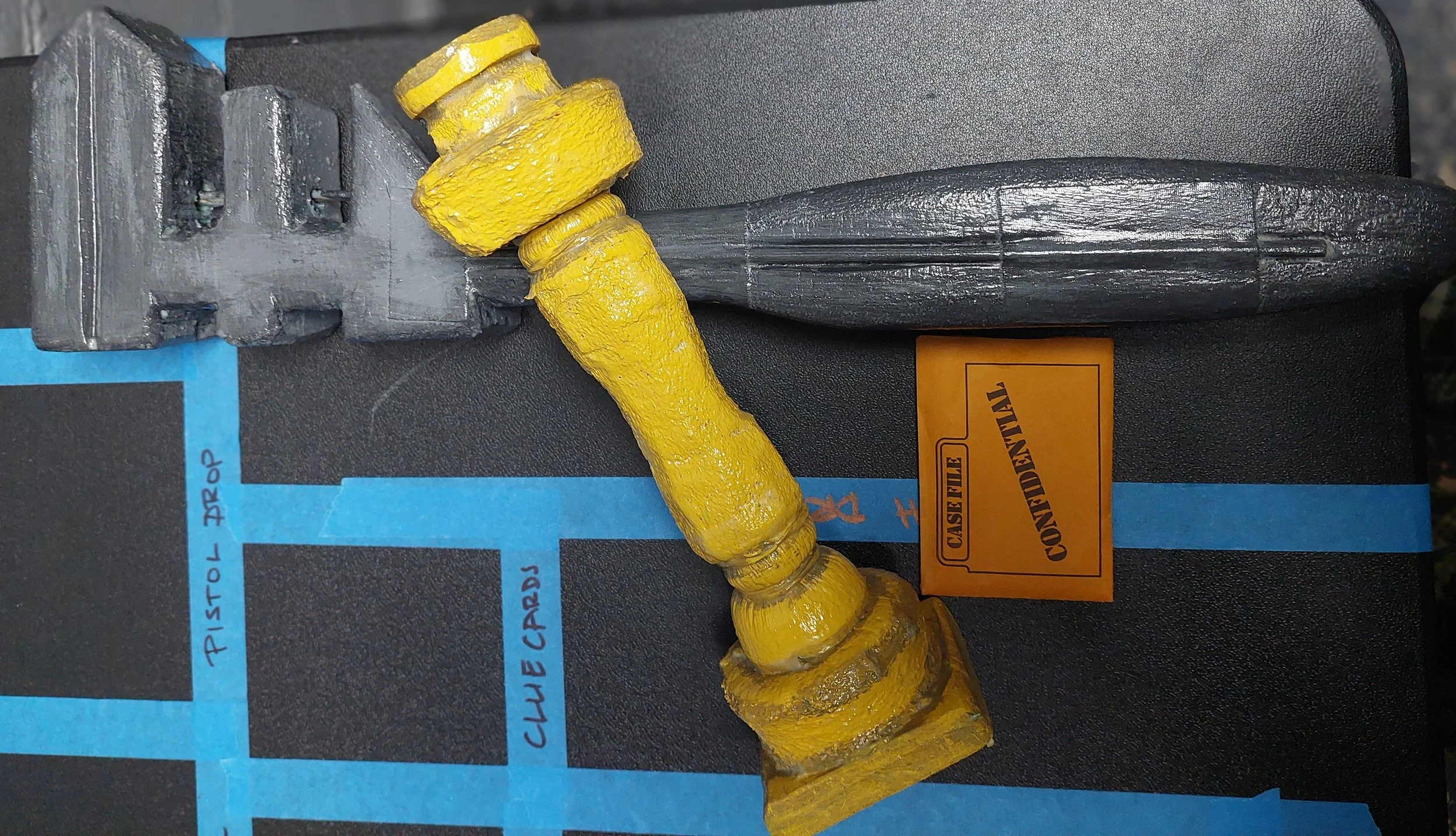 Wrench and Candlestick. Both hit-safe, carved and painted foam. The wrench is made of green foam and the candlestick of pool noodles. See bellow from progress photos.