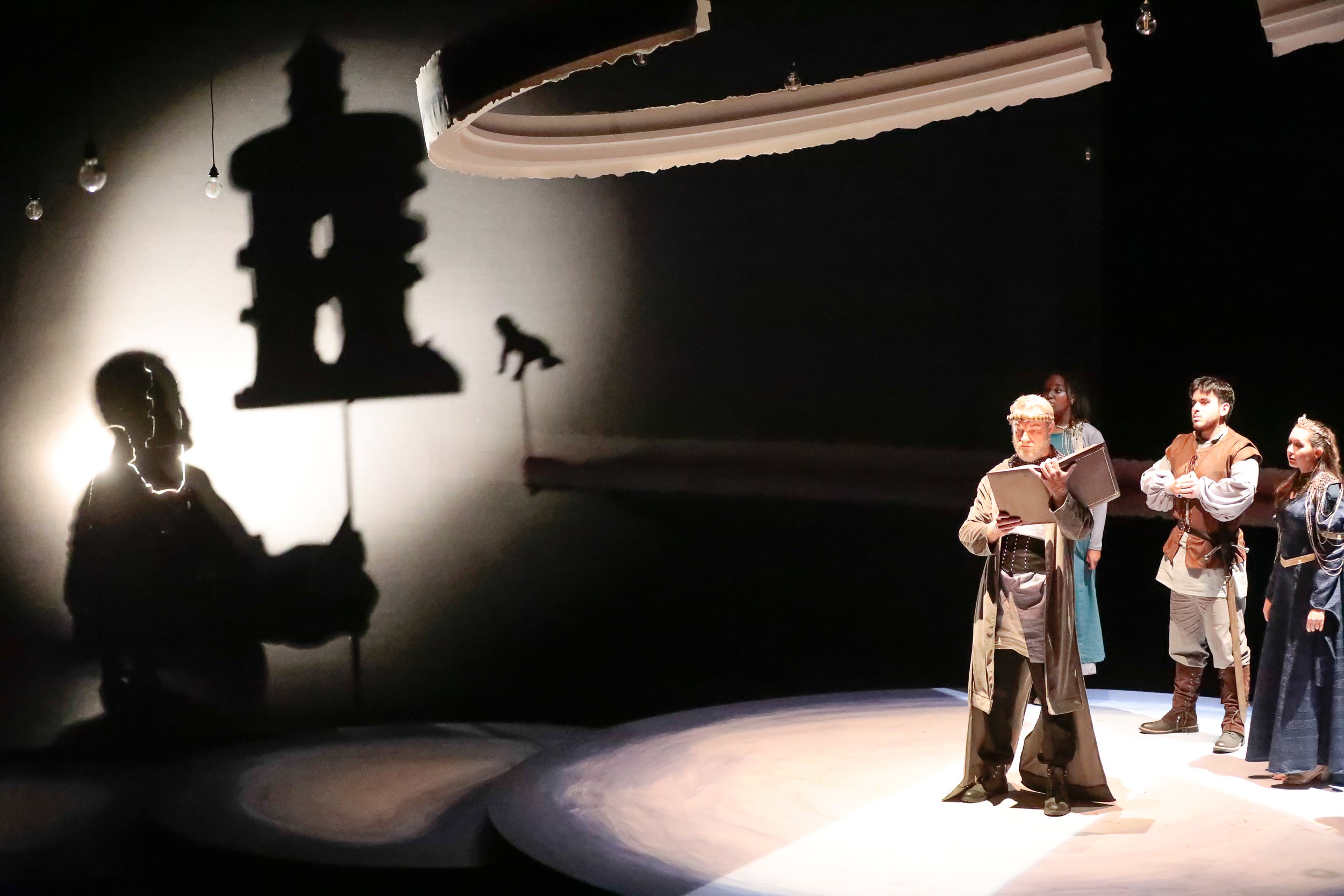 Shadow puppets used to tell the backstory of the play. The baby is sent to the prison tower.