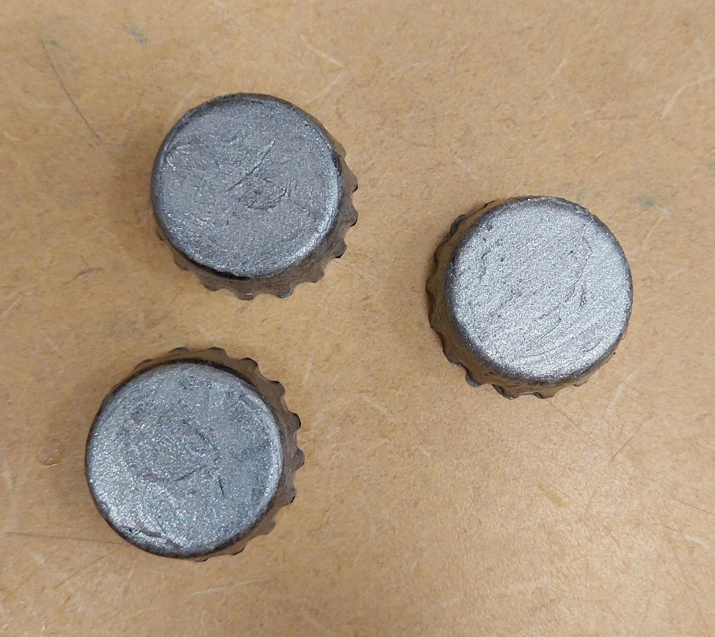 We ordered black and white, silicone bottle caps, so they can be easily cleaned, put on and taken off. Using silicone calk and pigment, several recipes and methods were tested before coming up with one that was thin enough to paint, with enough cover