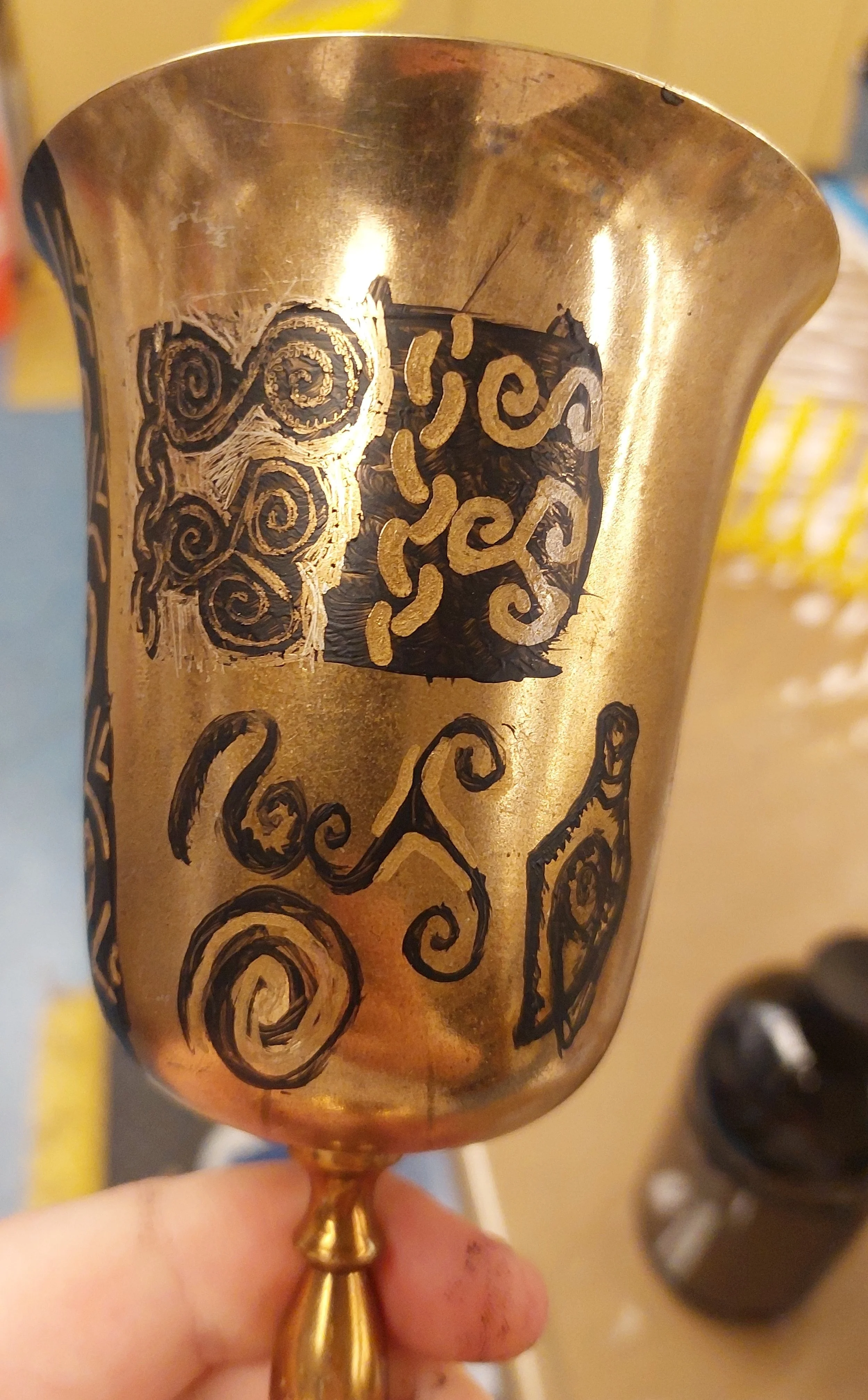 First method test, making spiral shapes look etched/inlaid. Clockwise from top left: painting black then scraping away, painting black then painting gold, just painting black, and painting black then highlighting with gold.