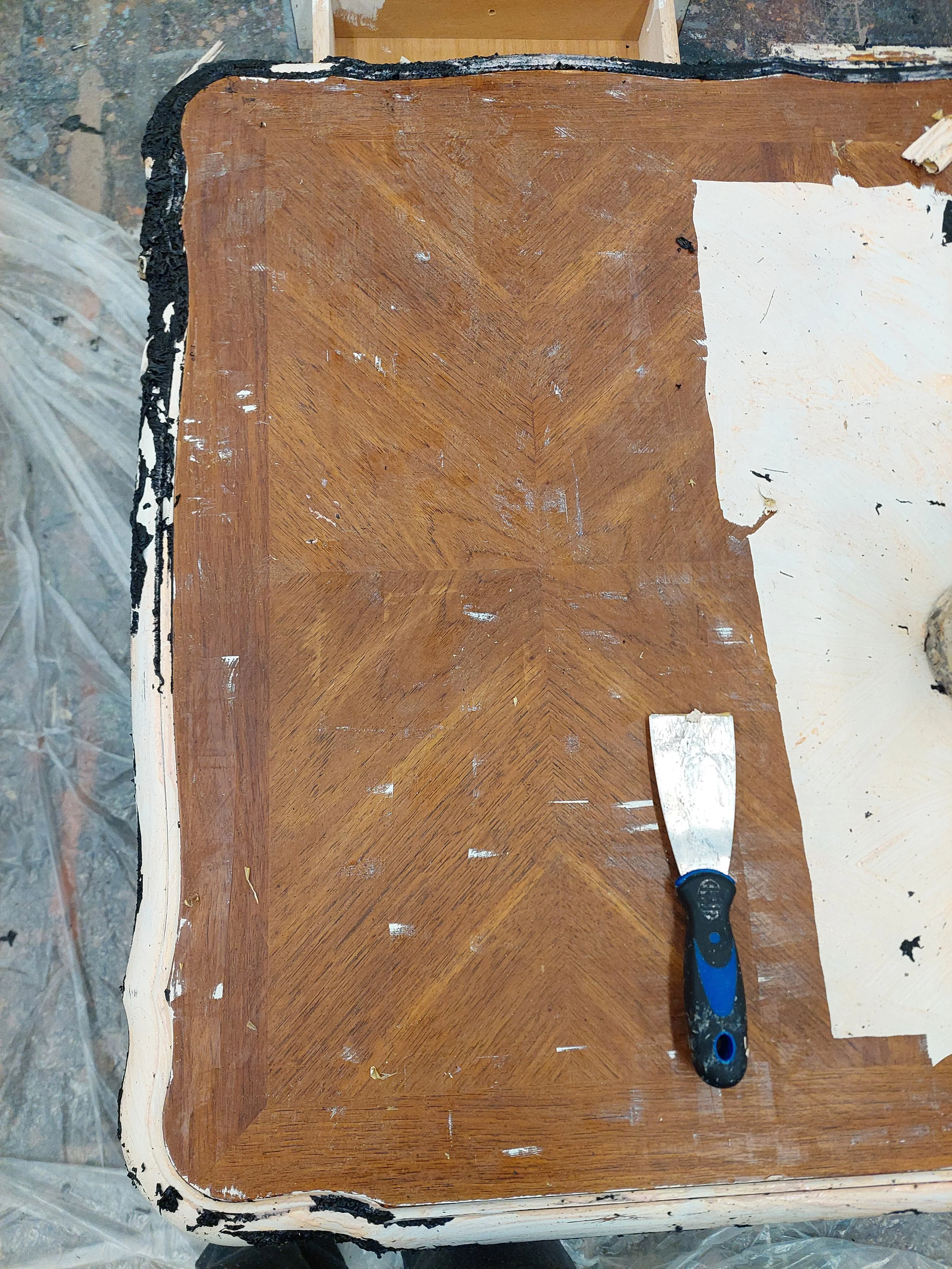 End of Day 3. Discovered after several layers that the top had a beautiful decorative inlay, that was being revealed quite easily. Used 2" metal scraper on the flat sections after 2, thick, 30 minute coats of CitruStrip. Discovered that the spirals a