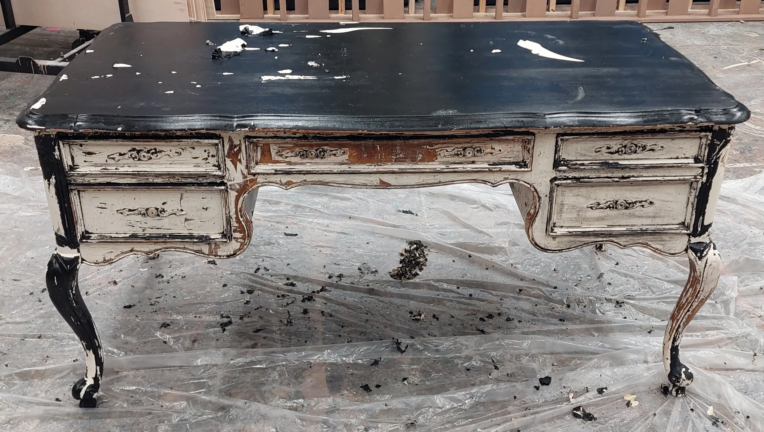 Beginning of day 3. Started to use a heat gun to peel away the larger areas of black latex paint. Used the drawers as test areas trying CitruStrip cover vs uncovered, in various thicknesses and lengths of time.Using a triangular pallet knife and a 2”
