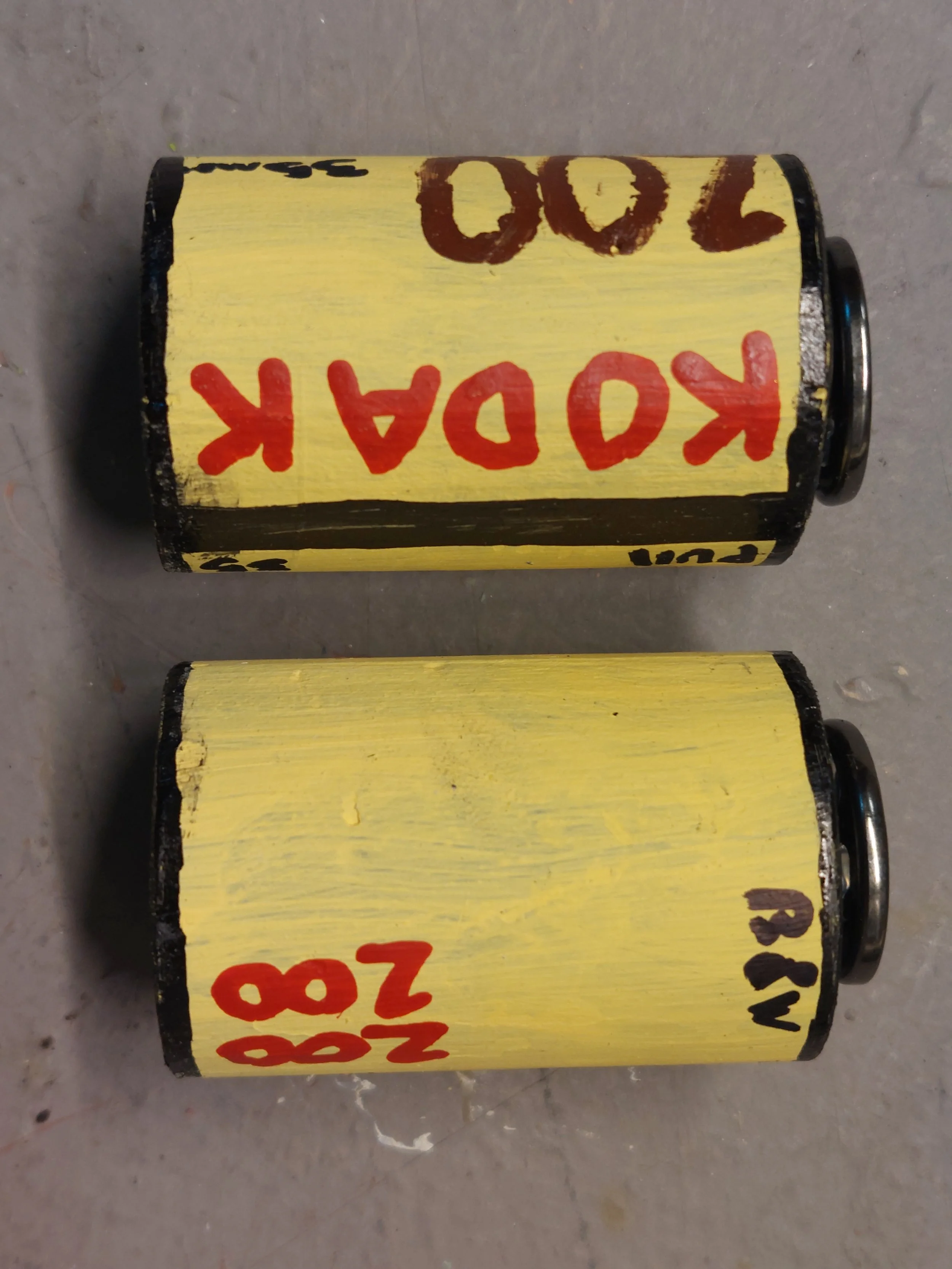35mm Film Rolls, made of 1" dowel, snaps and paint.