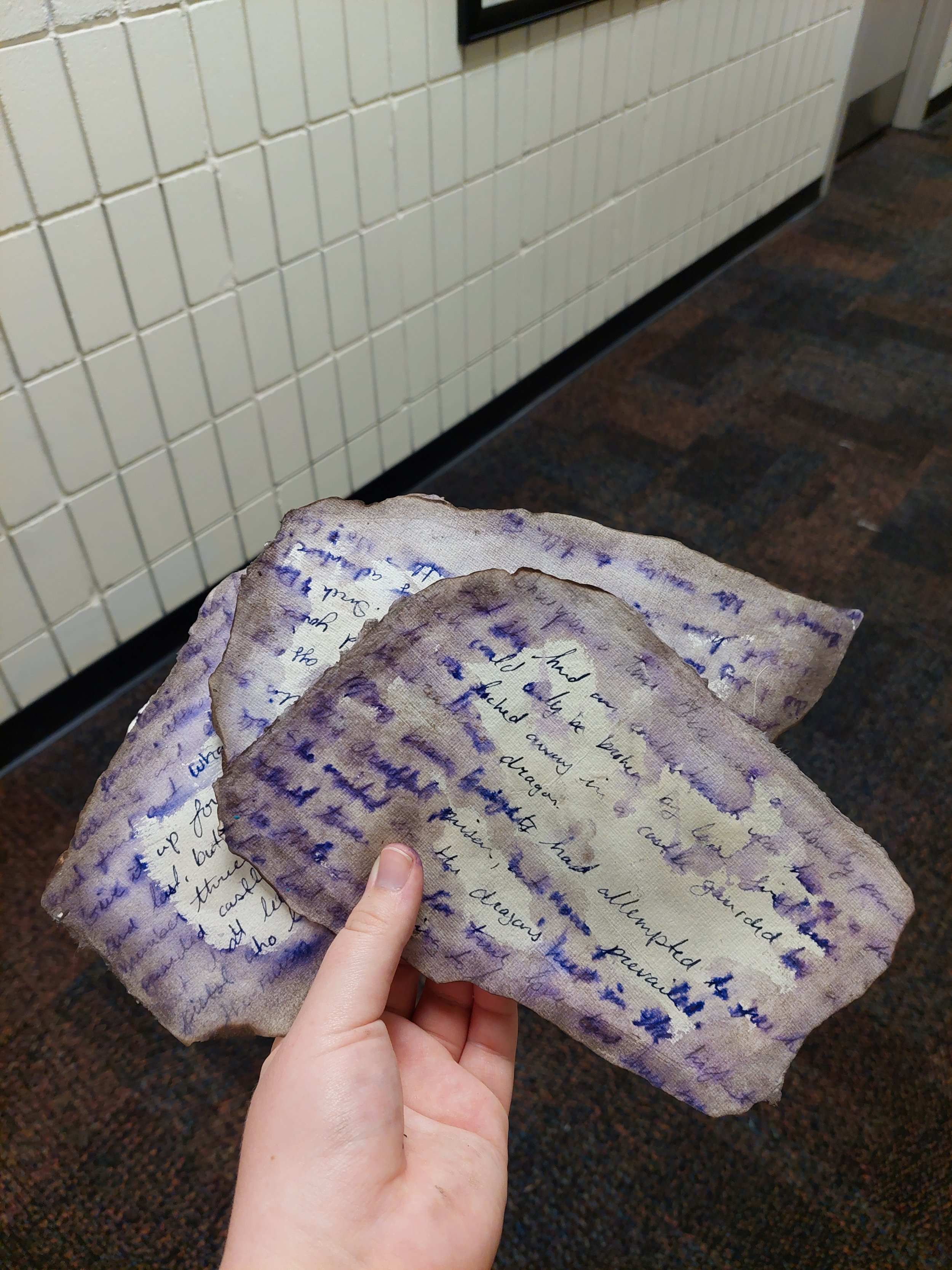 Faux burned pages, made by dabbing water onto water soluble ink then steam ironing.