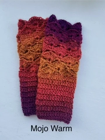 Crochet fingerless gloves in warm autumn colours of red, orange and purple. Made with acrylic yarn in a subtle colour transition