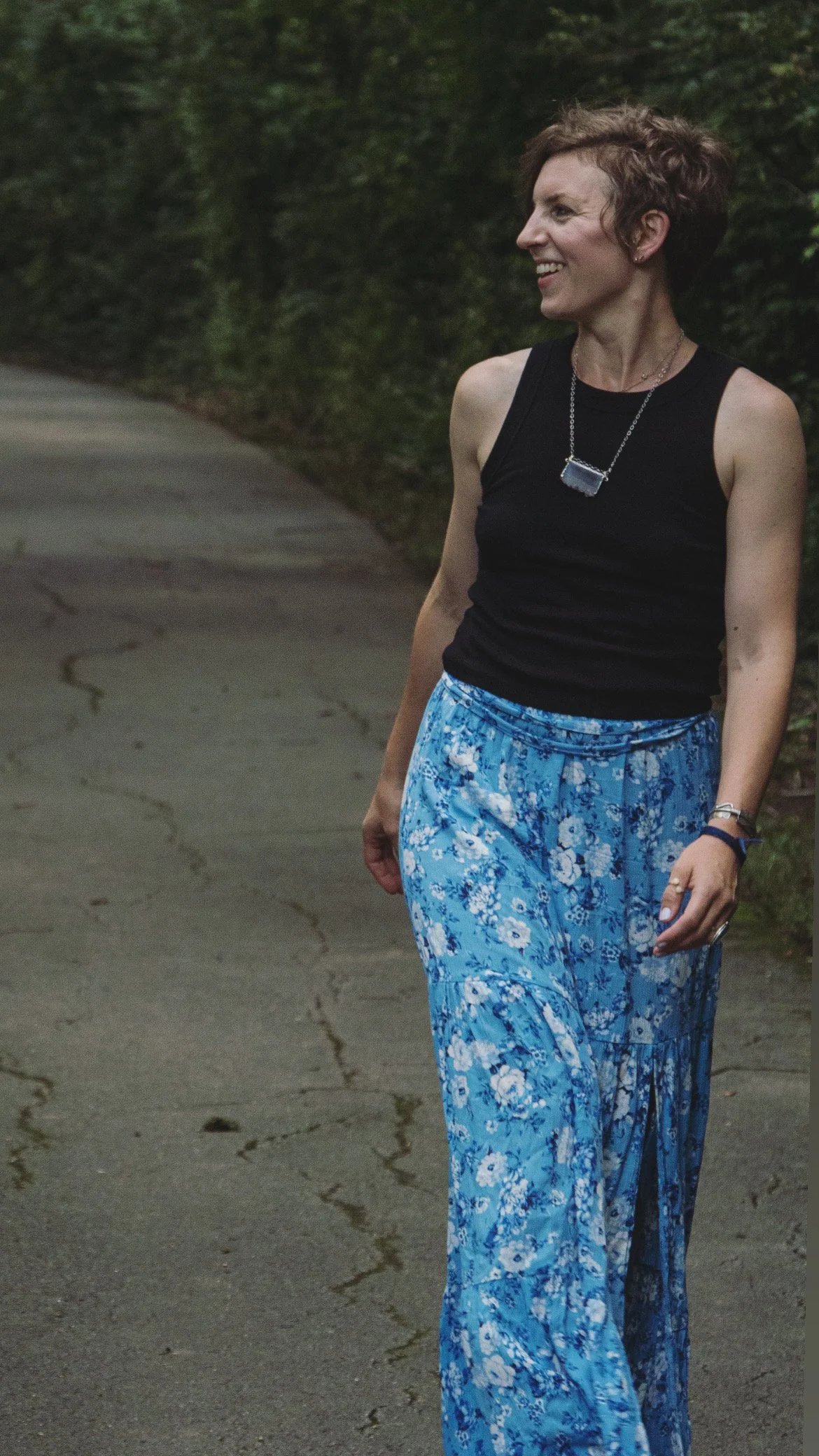 woman in pathway owner of Mama Expanded Nashville Doula Agency walking