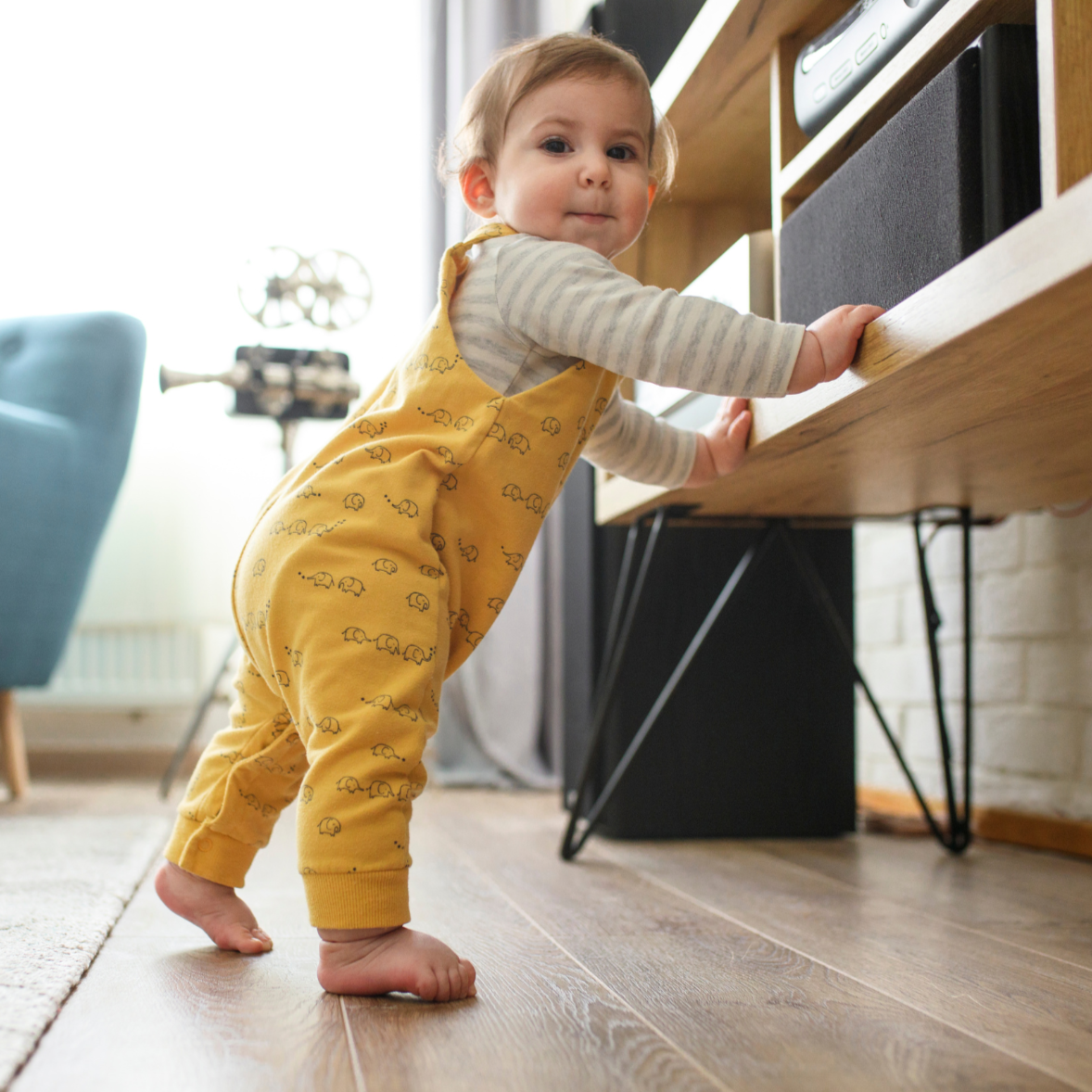 A toddler learning to walk with a push toy