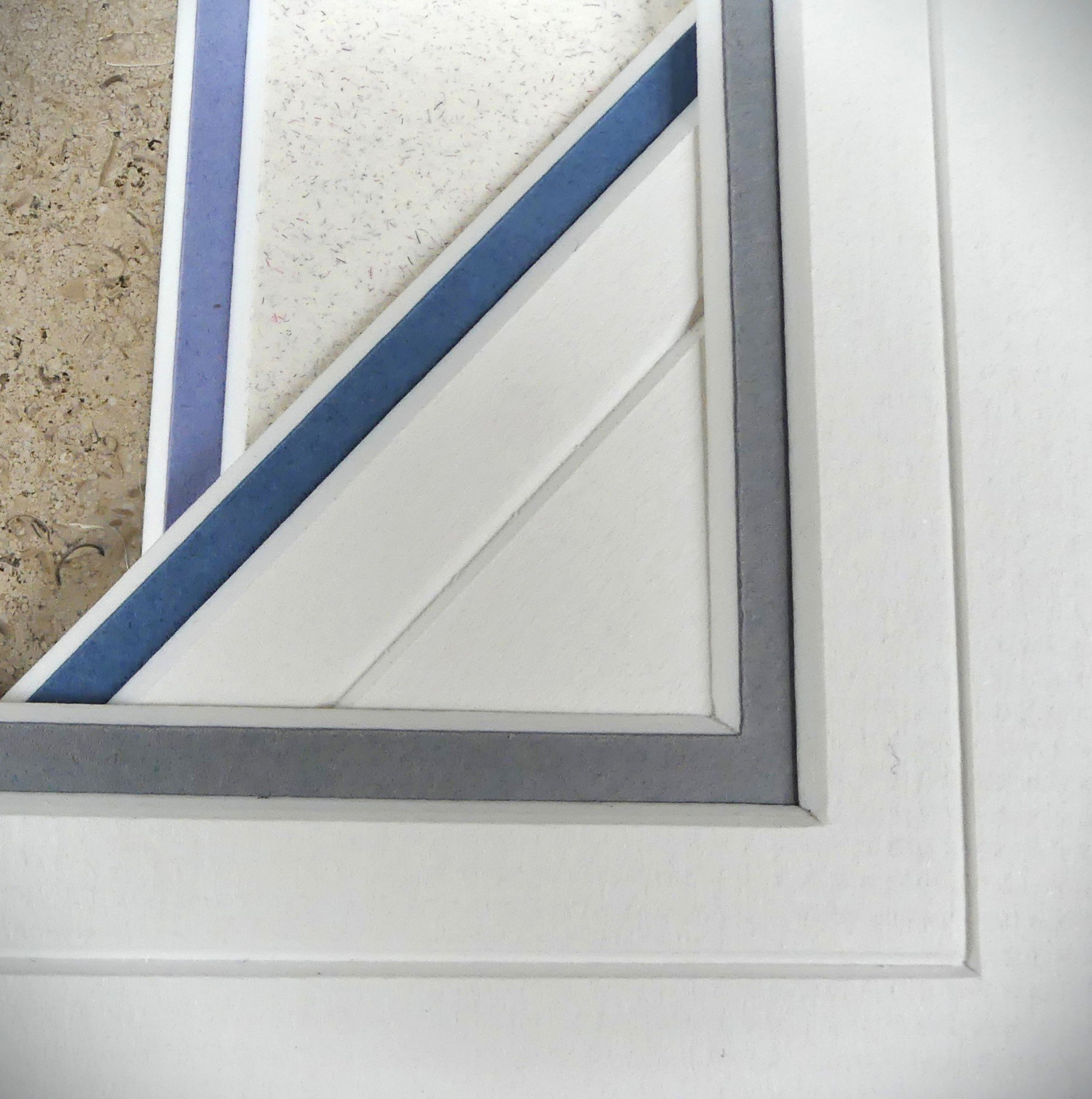 Close-up of a door frame with a section of the carpet and wall showing, including masking tape applied to the edges during painting.