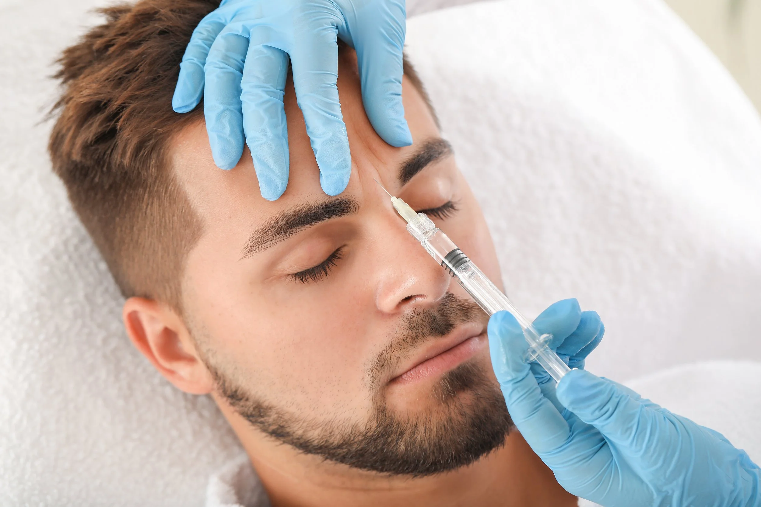 Patient receiving Botox brow lift for youthful and refreshed look in Birmingham clinic.