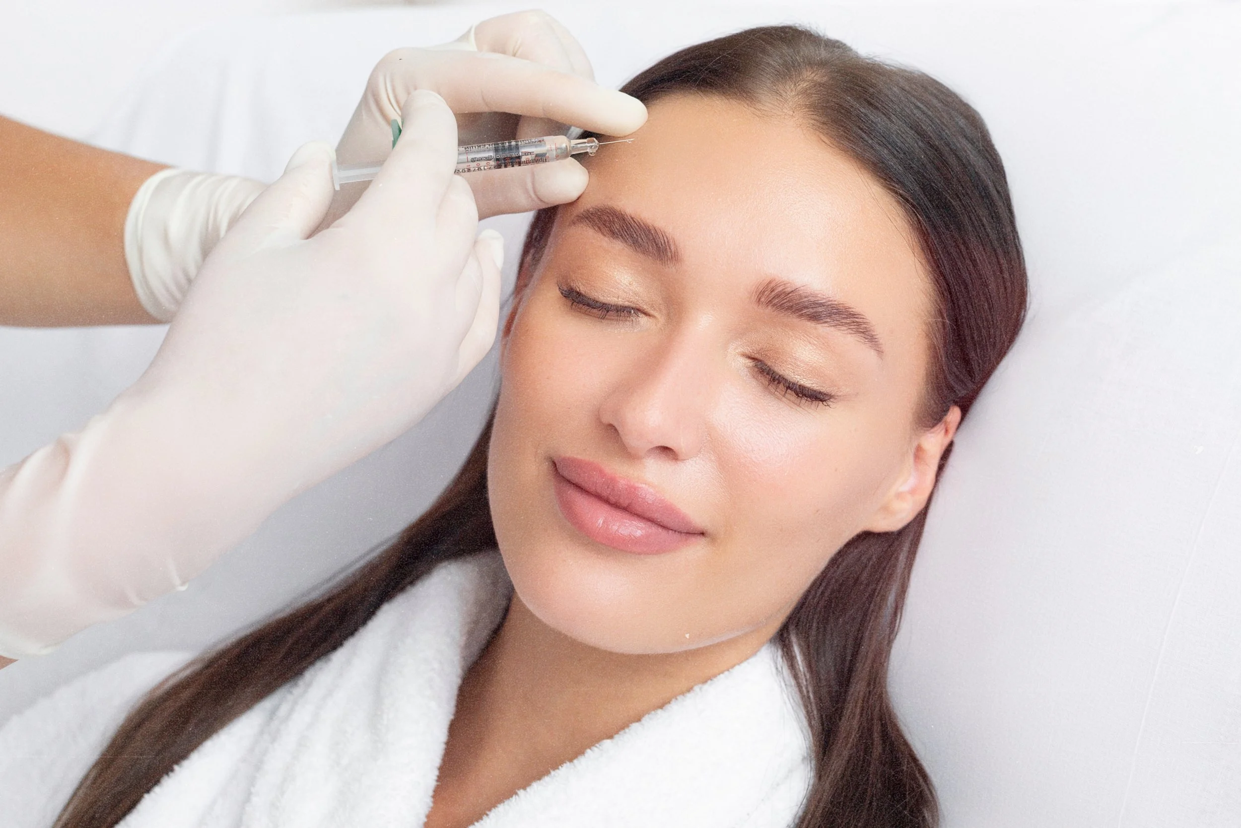 Dermal filler treatment for forehead wrinkles at Birmingham clinic.