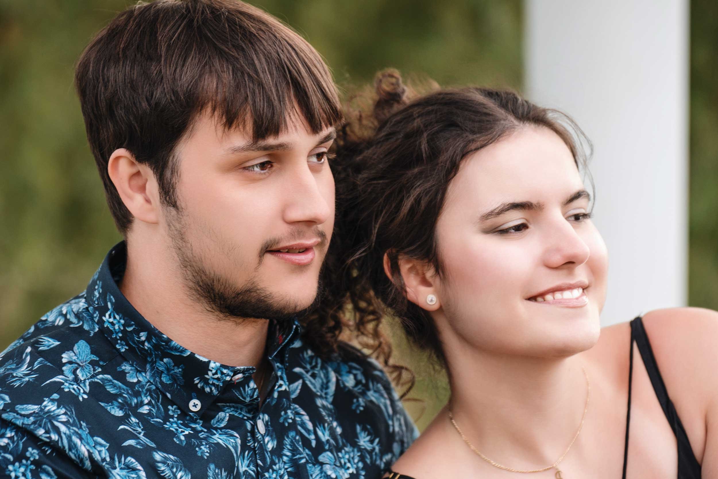A beautiful close-up portrait of a couple sharing a serene moment outdoors. Their relaxed expressions and soft natural light highlight their connection, creating a warm and intimate engagement photo.