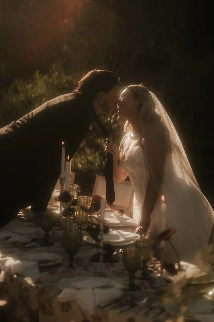 Bride and groom at candlelit dinner