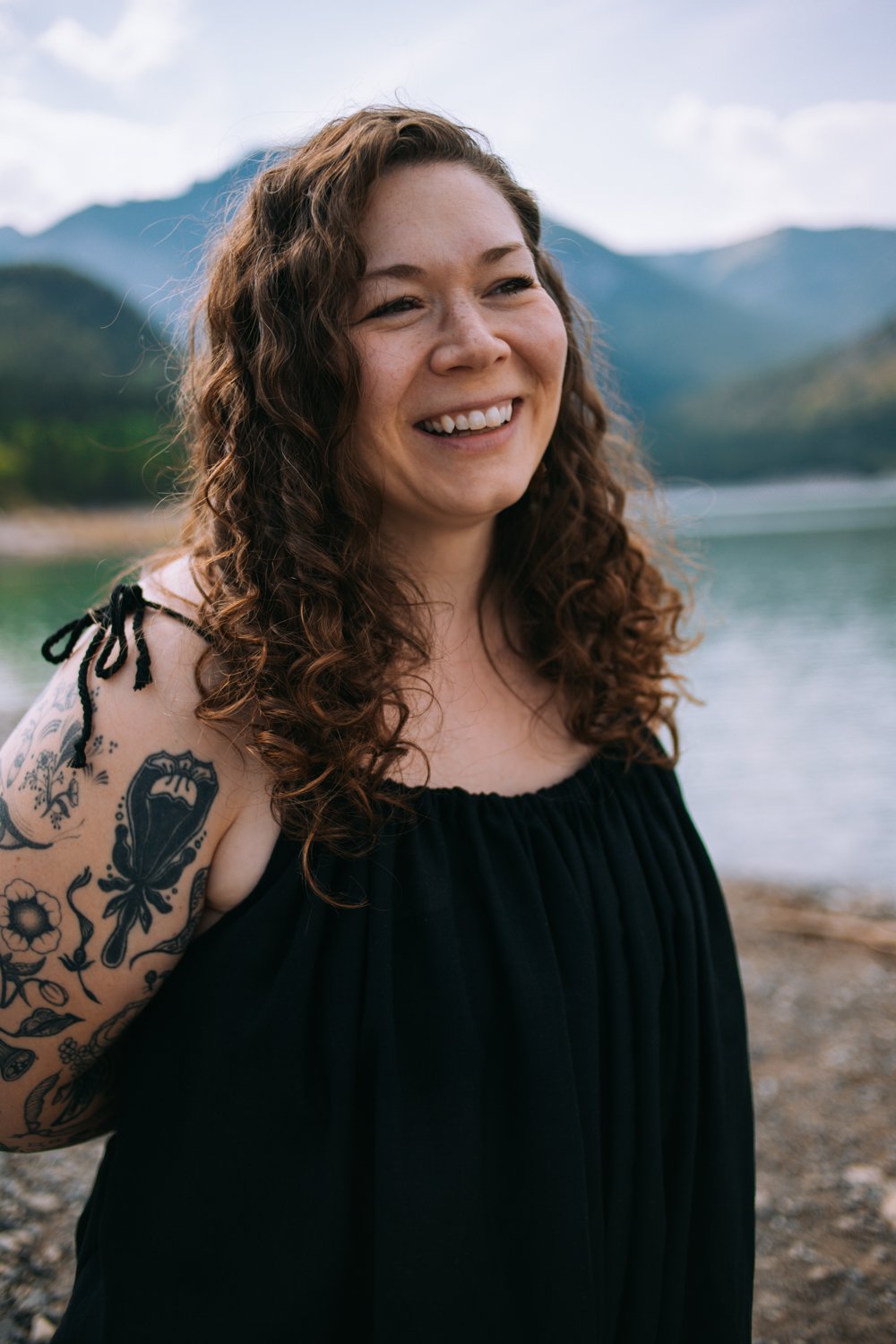 Jessica Huss smiling with mountains and lake in background