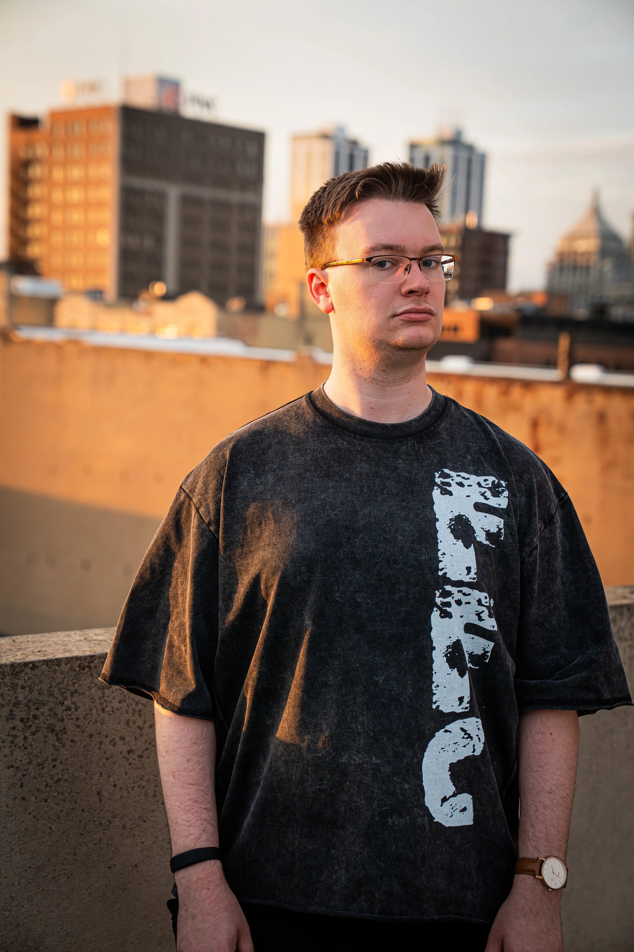 Benjamin Folgert of Frame Focus Creative wearing the FFC Vertical shirt on a rooftop in Peoria, IL.