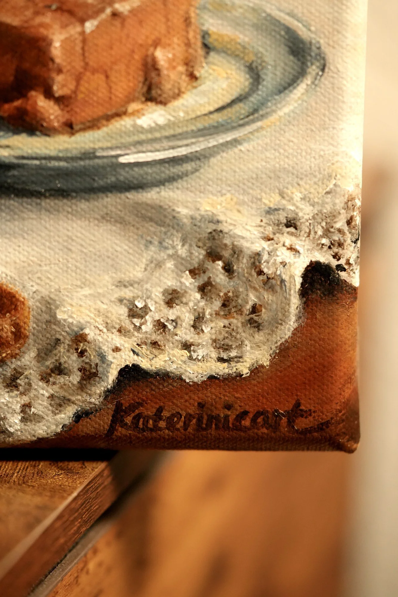Close-up of the artist's signature Katerinicart in the corner of an oil painting