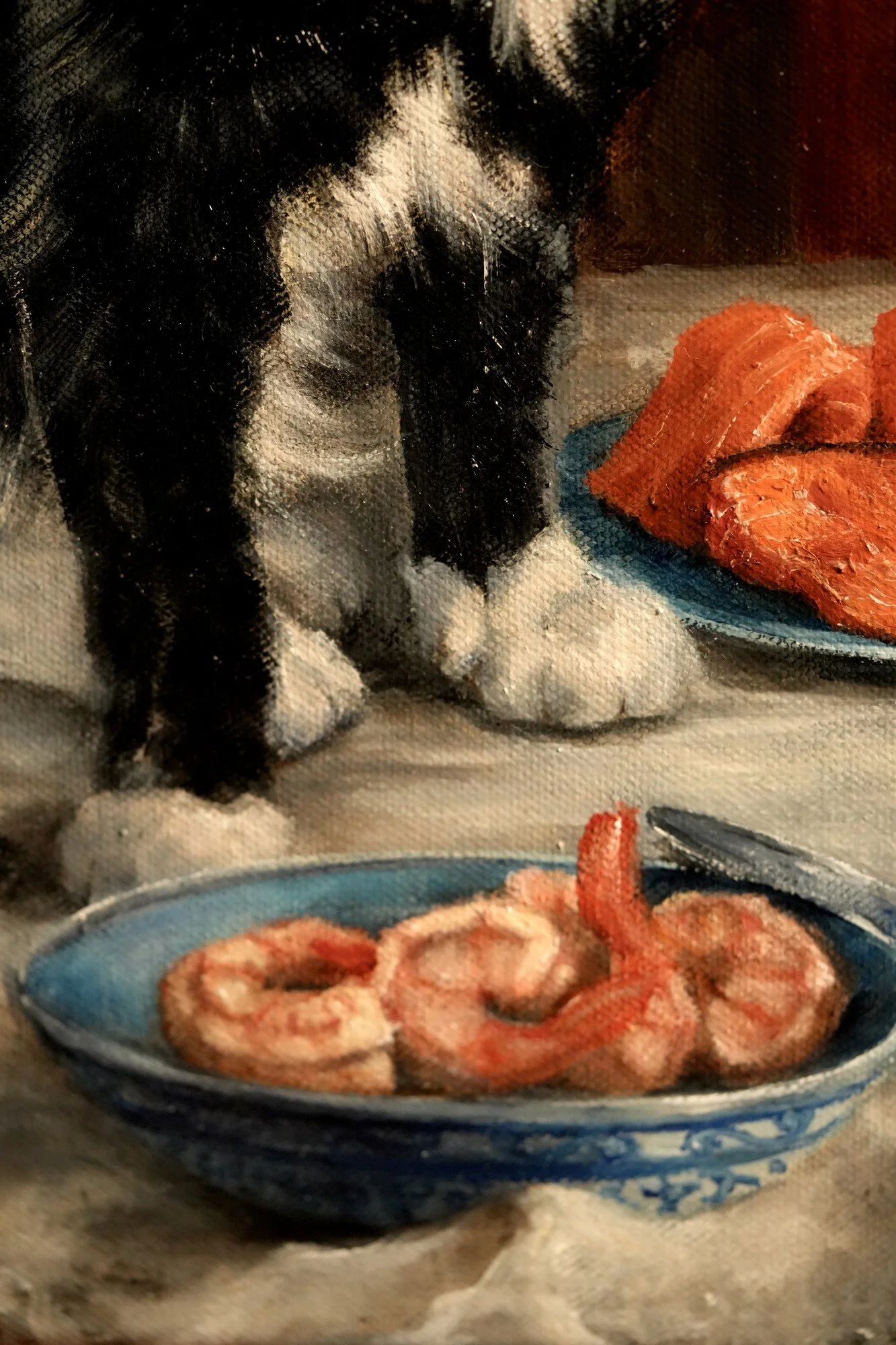 Detail of a cat's paws beside a bowl of shrimp and plate of salmon in an oil painting still life