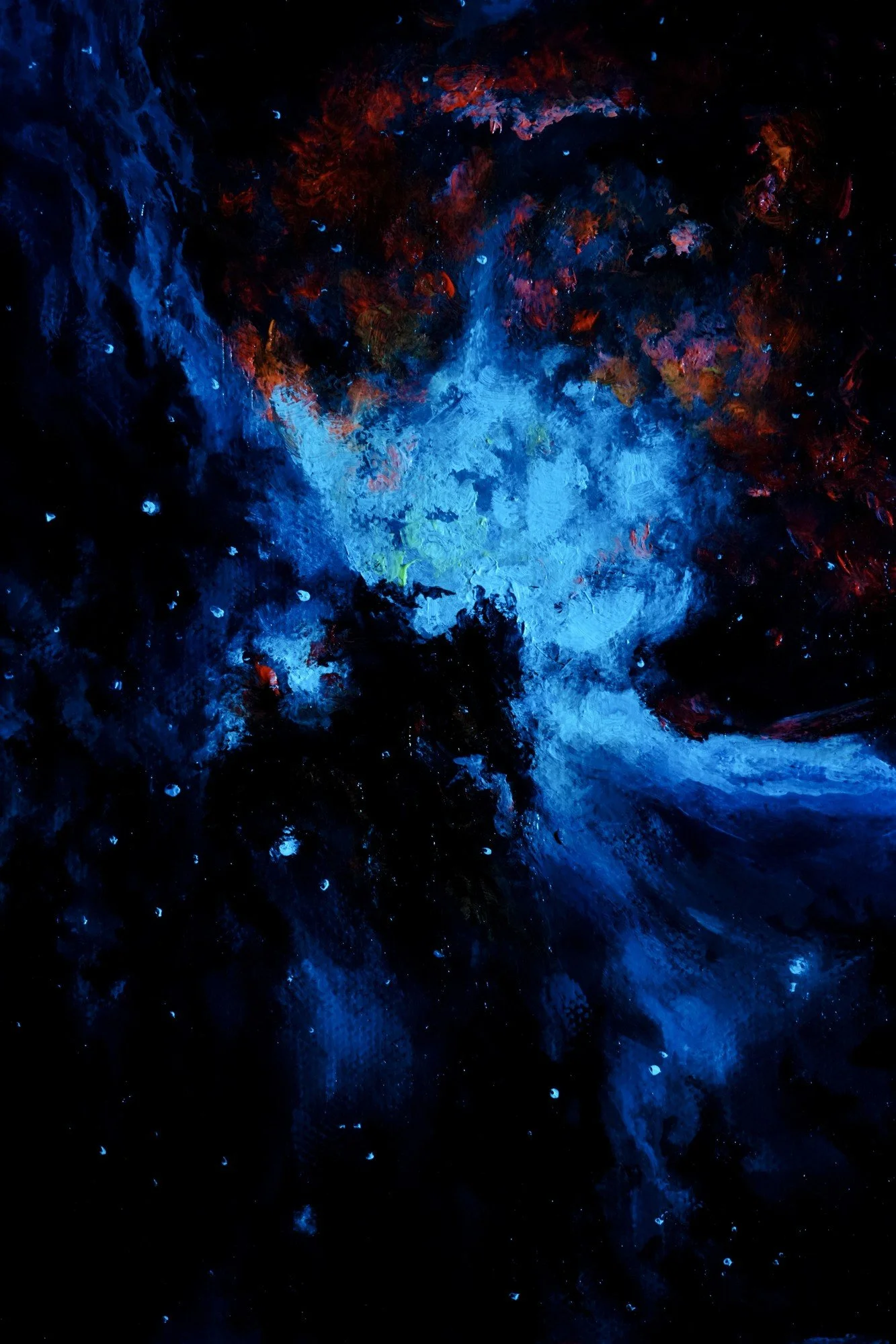 Close-up of phosphorescent glow-in-the-dark paint texture on a nebula painting under blacklight