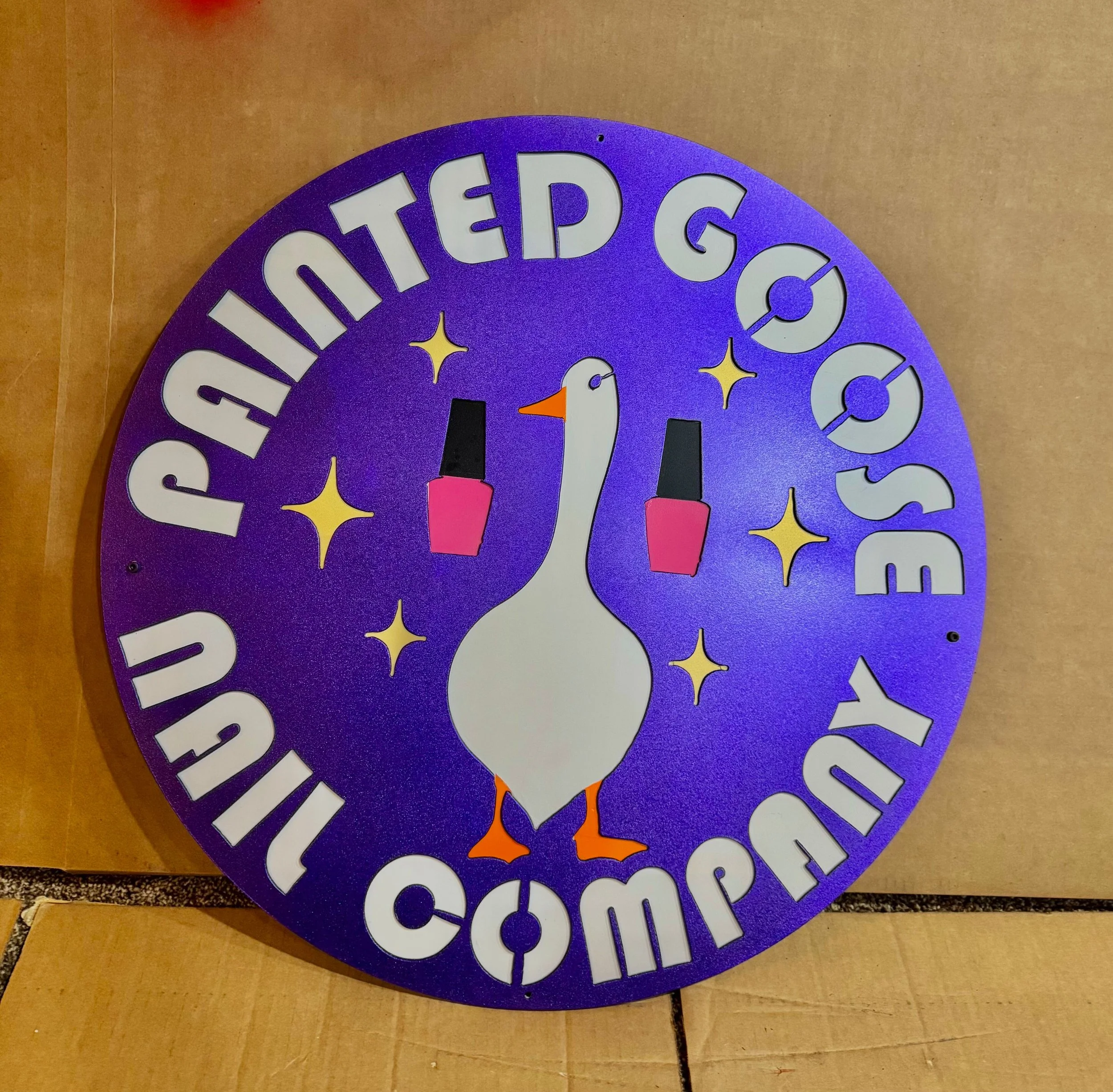 A decorative clock with a purple background, featuring a white duck in the center, surrounded by the phrases 'You have ducked good' and 'You are quacking awesome,' with images of two pink nail polish bottles and yellow stars.