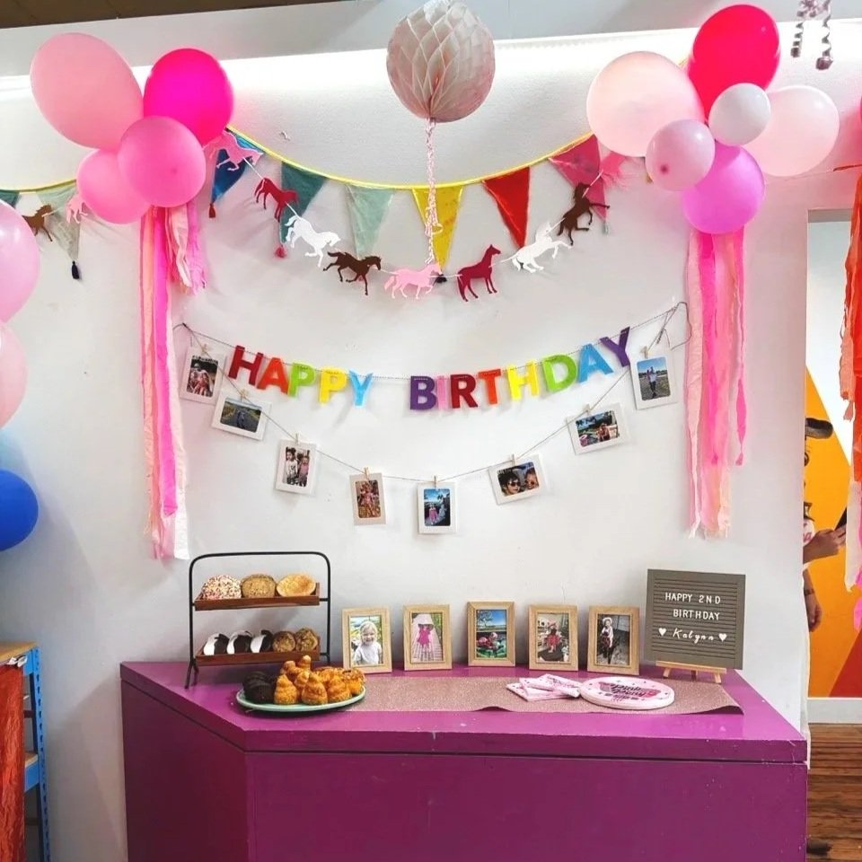 Custom themed party decor with a food and drink table set up for a birthday celebration