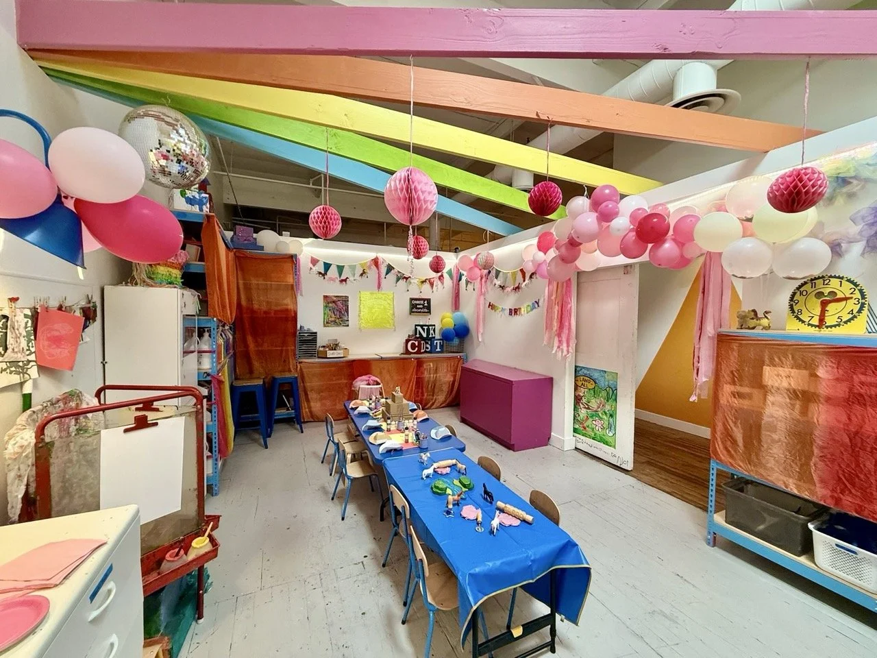 Party room decorated with colorful birthday banners